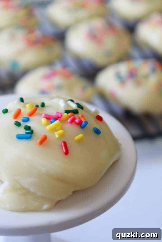 Festive Texas Sheet Cake Cookie Bites 2 Celebration Texas Sheet Cake Cookies recipe featured by top US food blog, Practically Homemade. A close-up shot of several frosted cookies with vibrant sprinkles.
