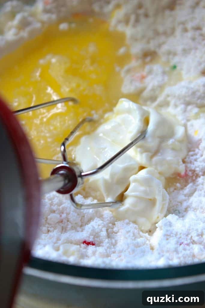 Festive Texas Sheet Cake Cookie Bites 5 Step 2: Mixing wet ingredients into the cake mix for the cookie dough.
