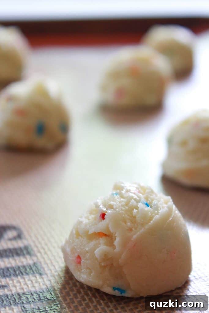 Festive Texas Sheet Cake Cookie Bites 6 Step 3: Scooping cookie dough onto a parchment-lined baking sheet for baking.