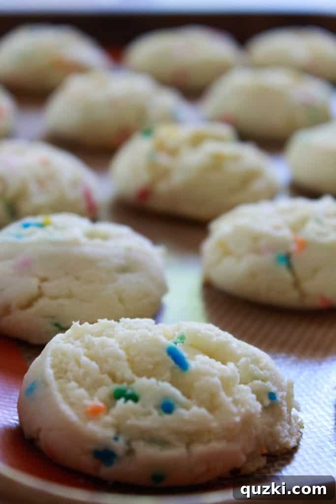 Festive Texas Sheet Cake Cookie Bites 7 Step 4: Baked cookies cooling on a baking sheet, showcasing their soft texture.