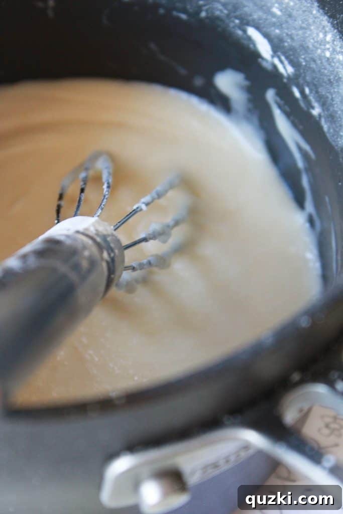 Festive Texas Sheet Cake Cookie Bites 8 Step 5: Preparing the cooked frosting in a saucepan, showing its smooth consistency.