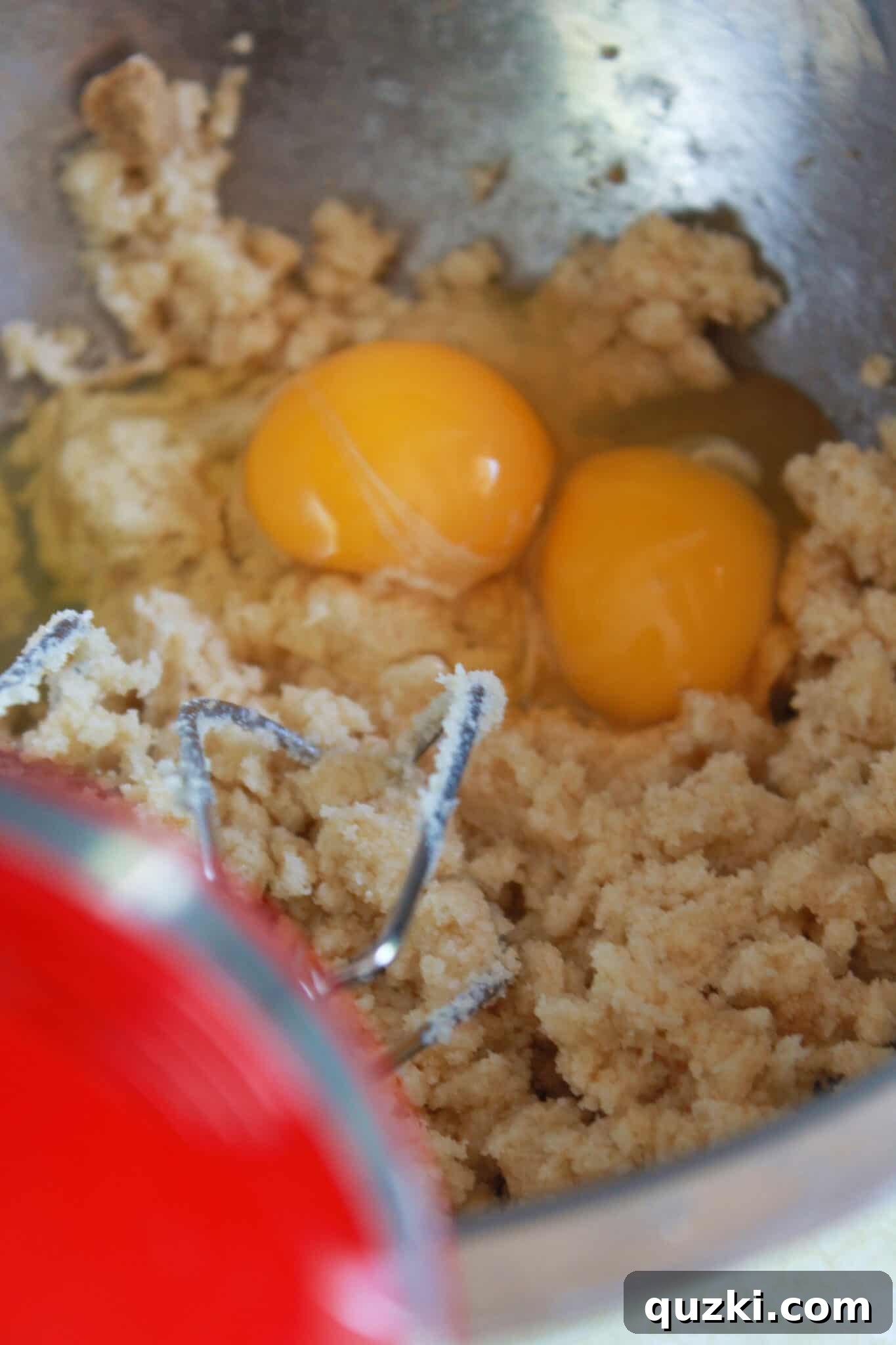 Effortless Zucchini Crumb Cake 5 The process of mixing the crumb cake batter, showing eggs being added and incorporated.