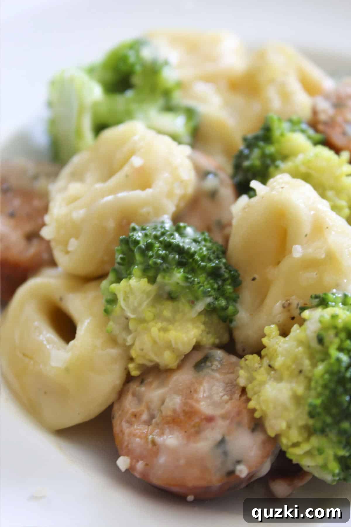 Single Skillet Sausage Tortellini Supper 2 Sausage and Tortellini Skillet with fresh broccoli, perfectly cooked and served on a white plate, ready to be enjoyed.