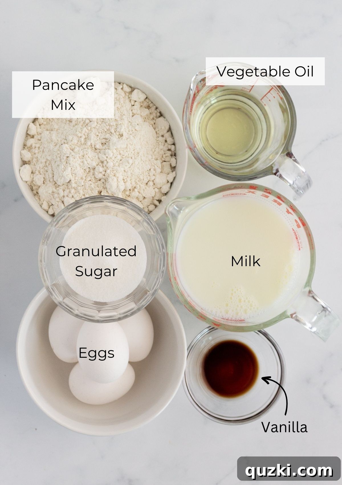 One-Pan Pancake Mix Magic 3 A selection of essential ingredients laid out for making sheet pan pancakes, including pancake mix, eggs, milk, sugar, oil, and vanilla extract.