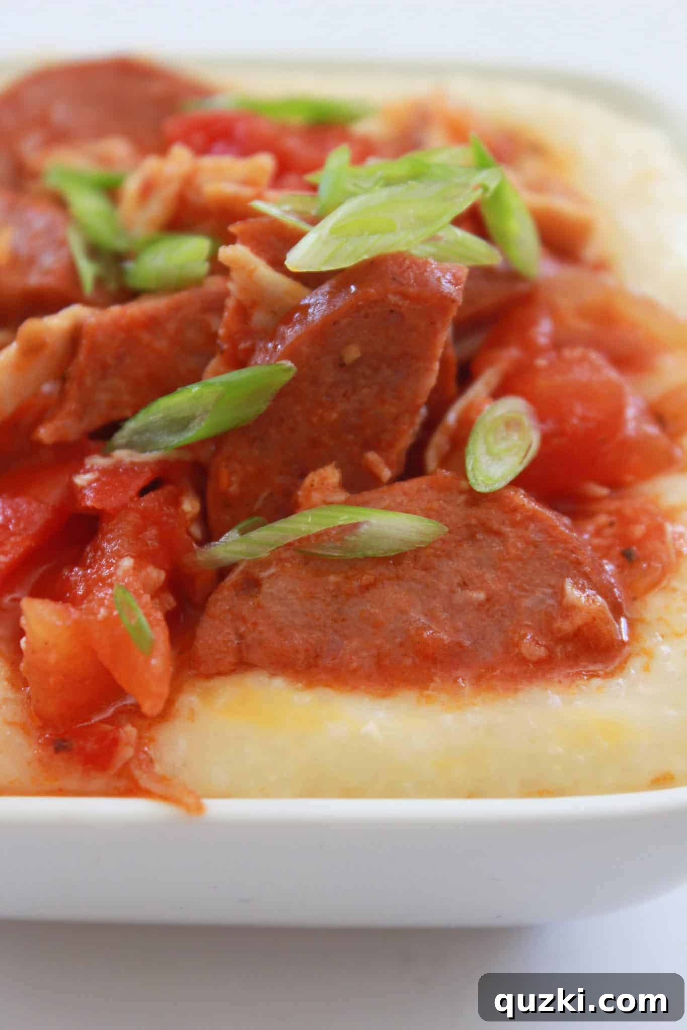 A bowl of 15-Minute Andouille Sausage and Cheese Grits, a quick and easy weeknight family dinner.