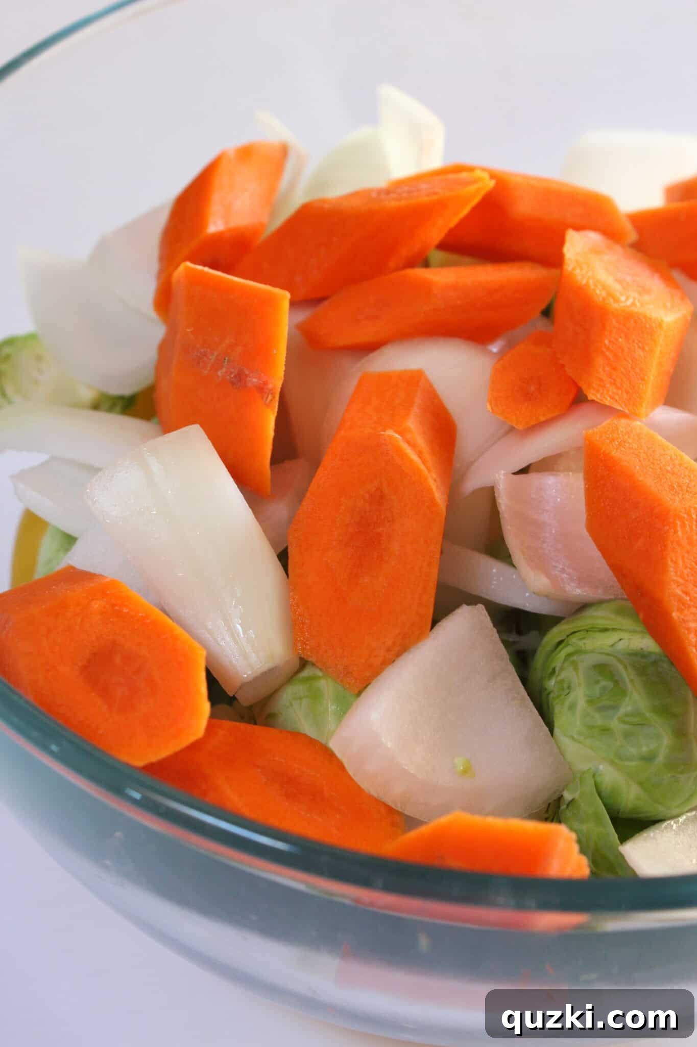 Tek Tepsi Sosisli Patates Lezzeti 10 Preparing fresh carrots by peeling and cutting them on the bias for an even cook.