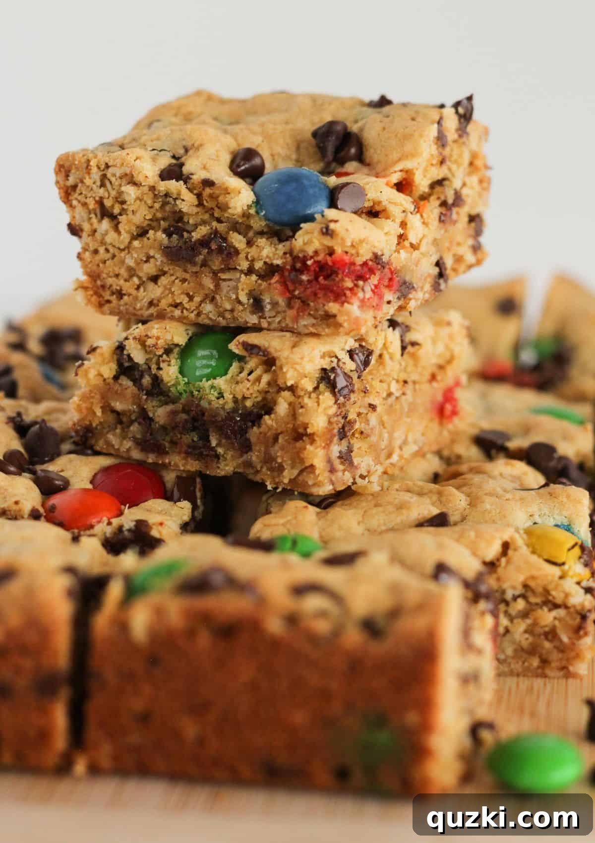 Close-up of a Monster Cookie Bar, showing the texture of oats, peanut butter, and colorful candies.
