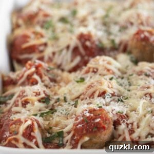 Finished meatball sub casserole in a white baking dish.
