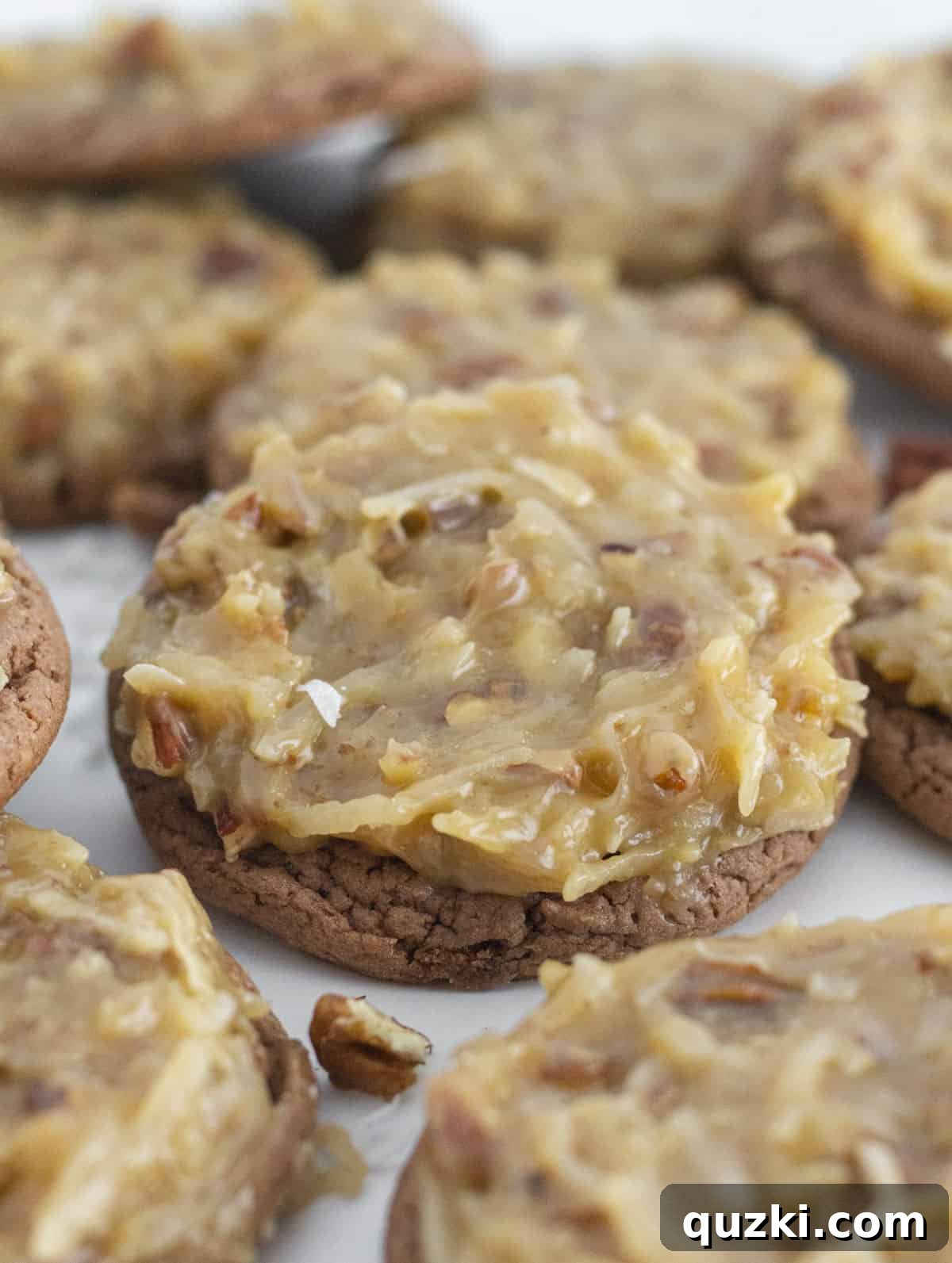 Pratik Alman Çikolatalı Kek Karışımı Kurabiyeleri 7 A tray filled with a dozen beautifully frosted German Chocolate Cake Mix Cookies, ready to be served.
