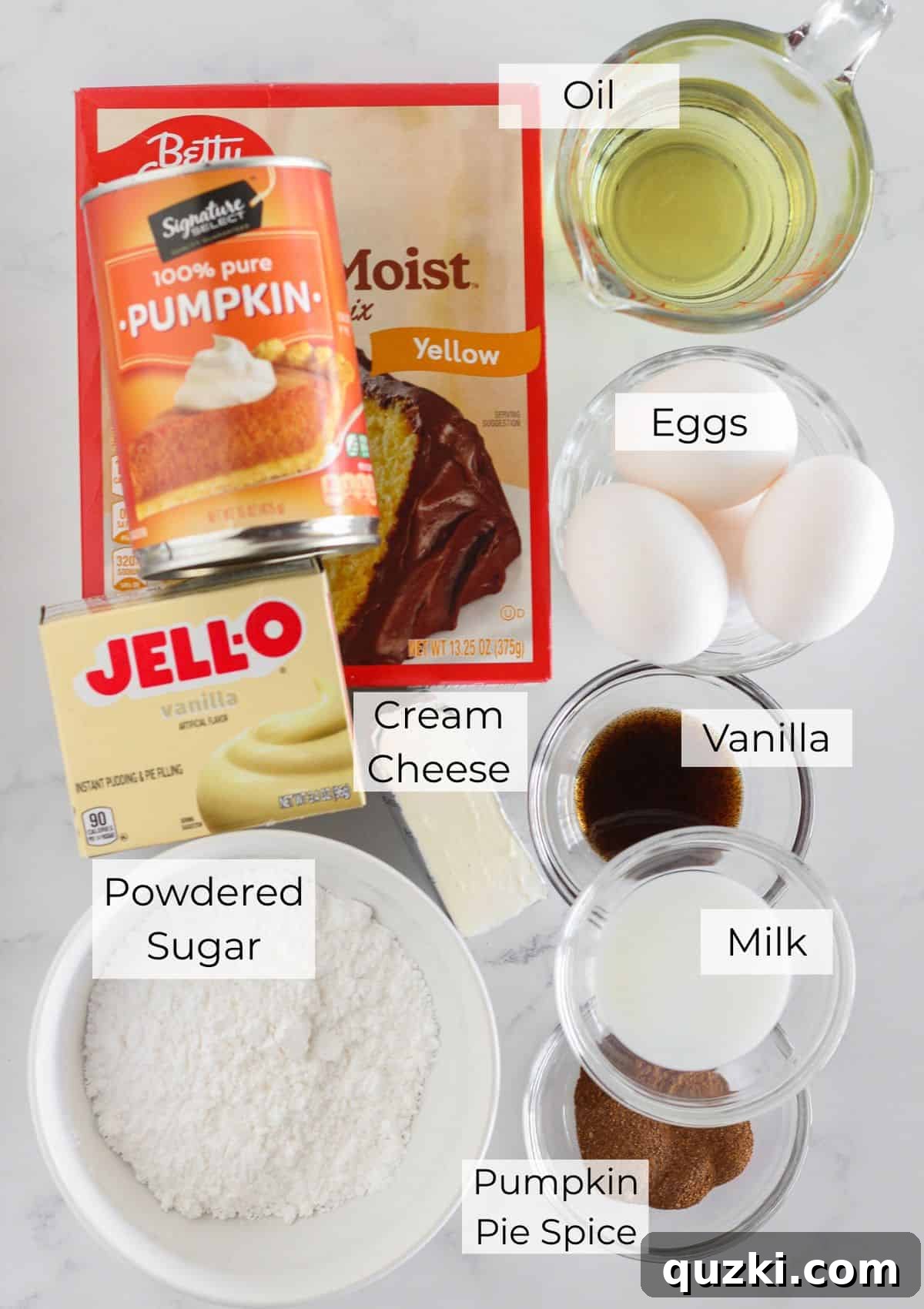 The essential ingredients laid out for preparing a pumpkin spice bundt cake.