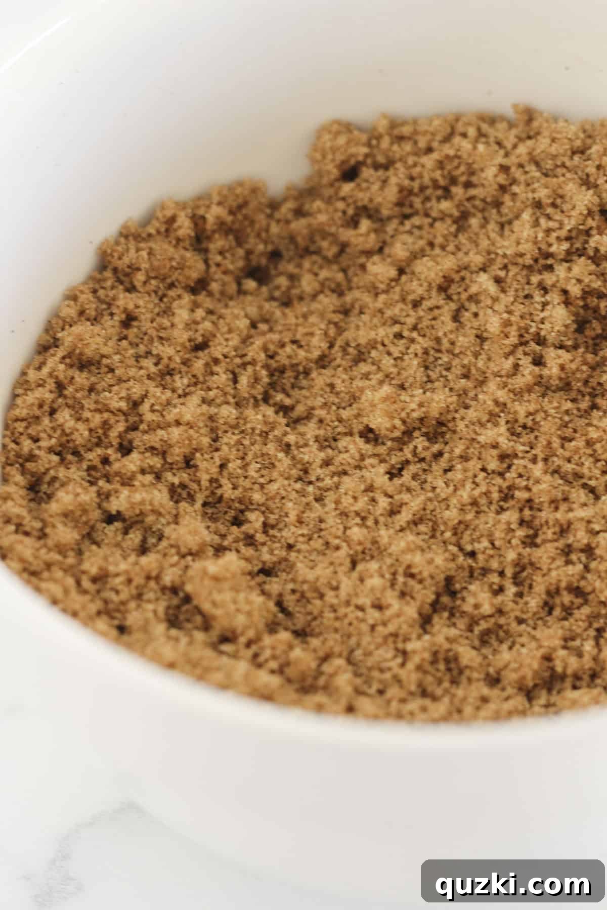 Combining brown sugar and ground cinnamon in a small bowl for the sweet cinnamon swirl mixture.