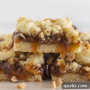 Close-up of Easy Toffee Cookie Bars stacked with visible gooey caramel and chocolate chips