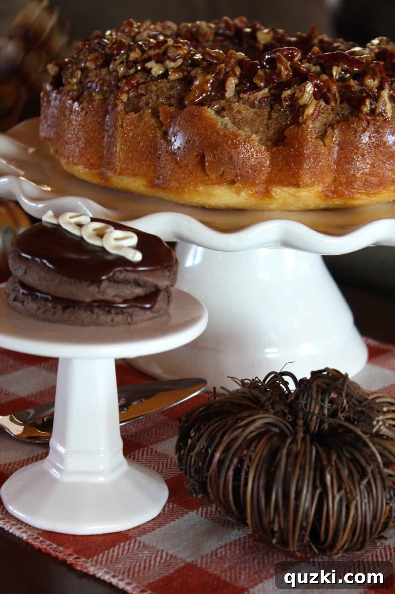 Pecan Upside Down Bundt Cake anchoring one end of the dessert table with other varied sweets.