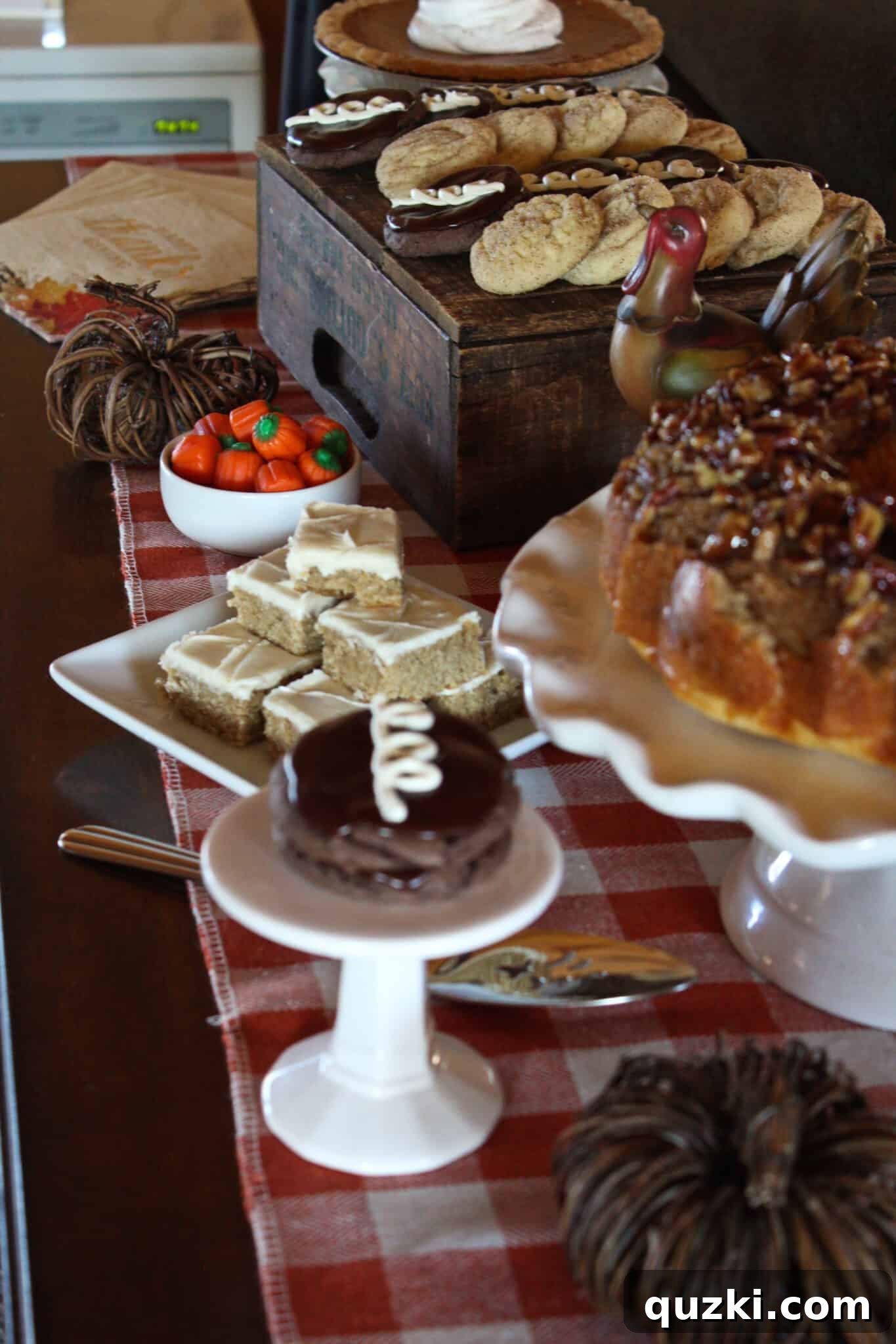 An elaborate Thanksgiving dessert table concept with multiple pies and tiered serving pieces.