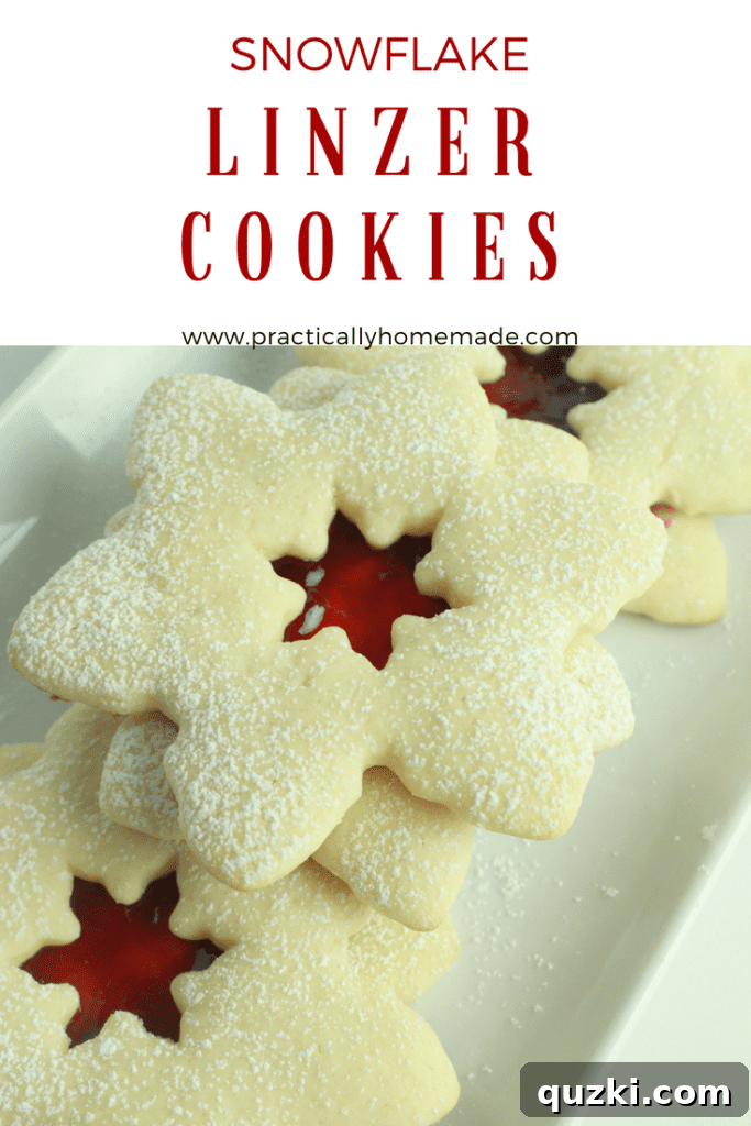 Cream Cheese Linzer Snowflakes 2 Beautifully dusted snowflake linzer cookies with raspberry jam filling, ready for holiday celebrations.