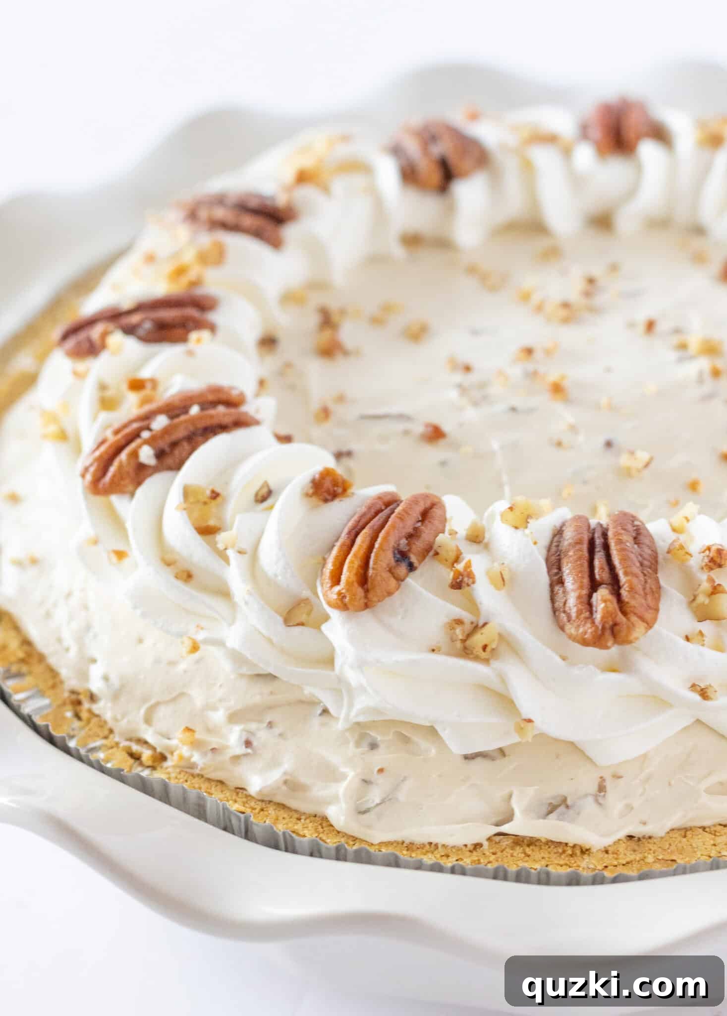 An irresistible Butter Pecan Cream Pie, featuring a rich cream cheese base and crunchy pecans, perfect for Thanksgiving.