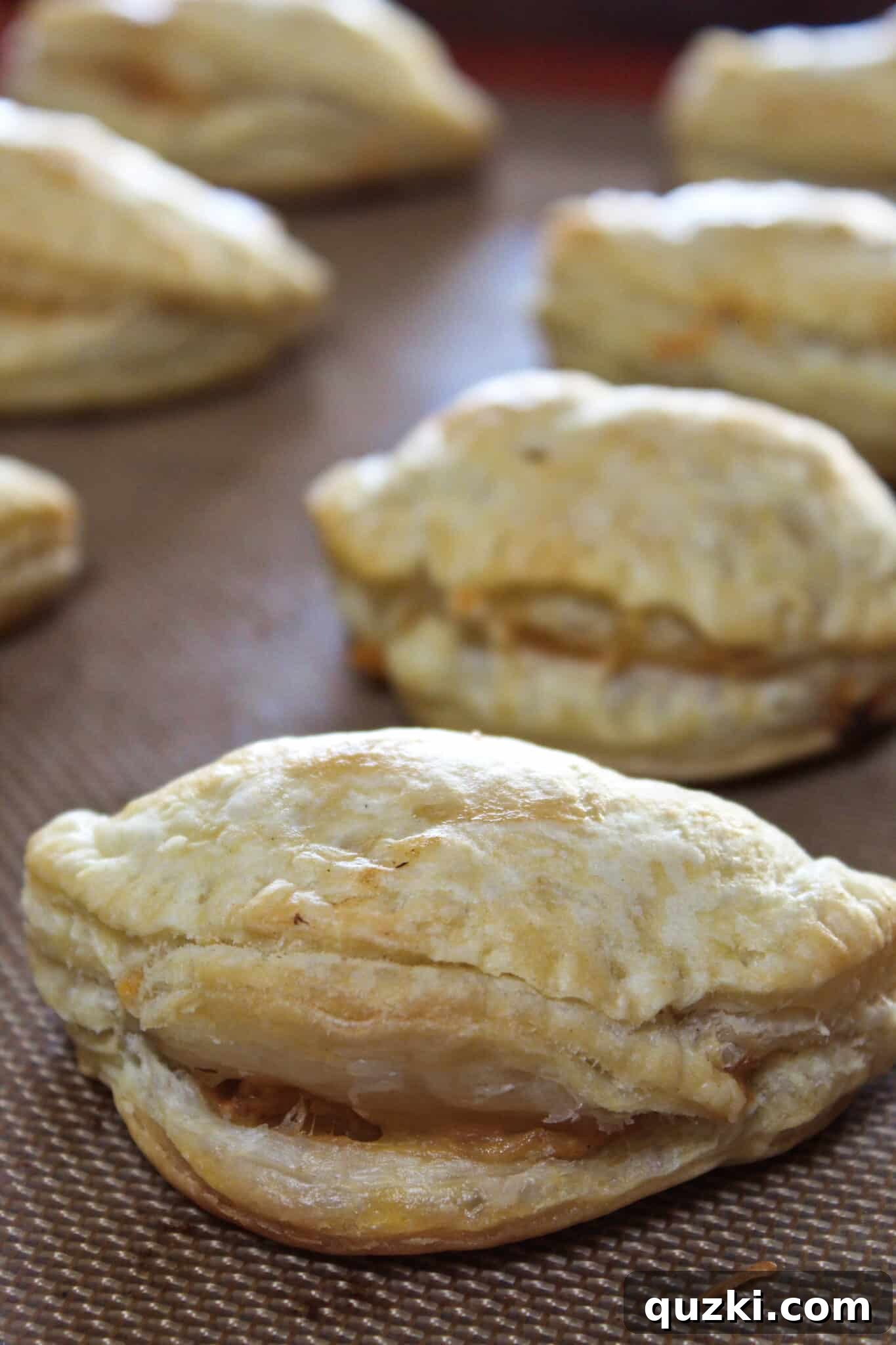 Thanksgiving Leftover Turkey Empanadas: A Delicious Reinvention 13 Freshly baked turkey empanadas, golden brown and perfectly puffed, served warm on a baking sheet.