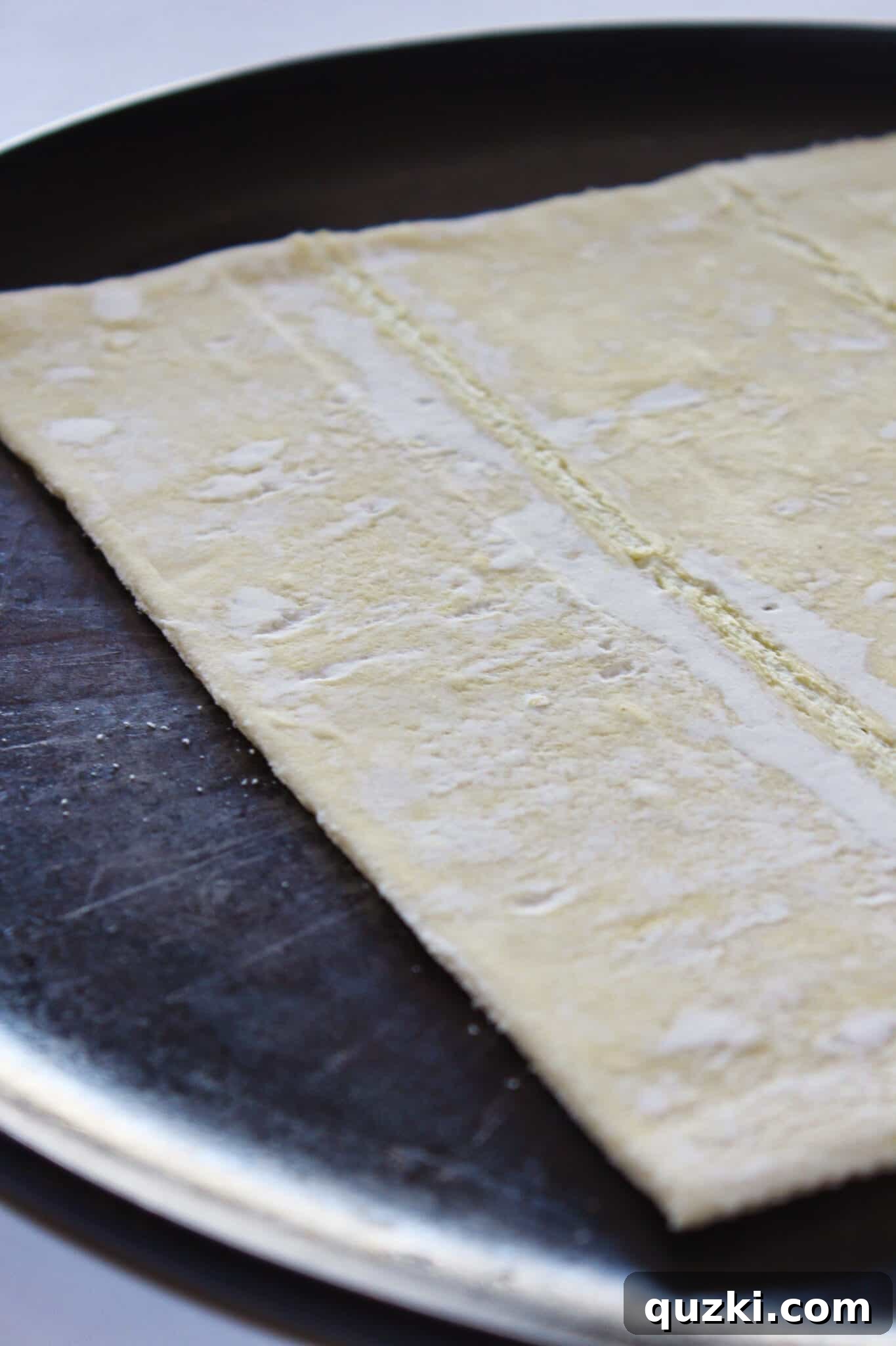 Thanksgiving Leftover Turkey Empanadas: A Delicious Reinvention 4 Thawed puff pastry sheet laid flat on a cutting board, ready for shaping into empanada crusts.