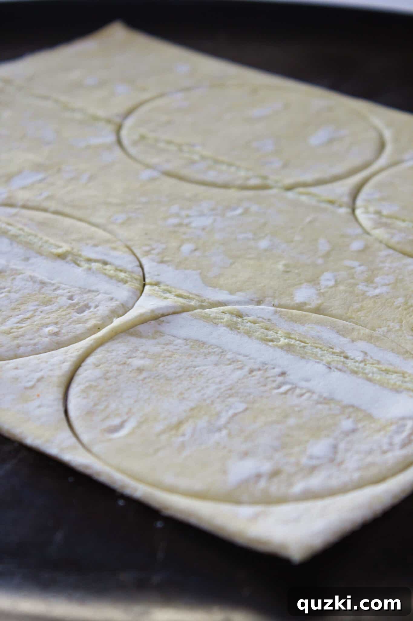 Thanksgiving Leftover Turkey Empanadas: A Delicious Reinvention 5 Puff pastry rounds neatly cut out with a cookie cutter, ready for filling and folding.