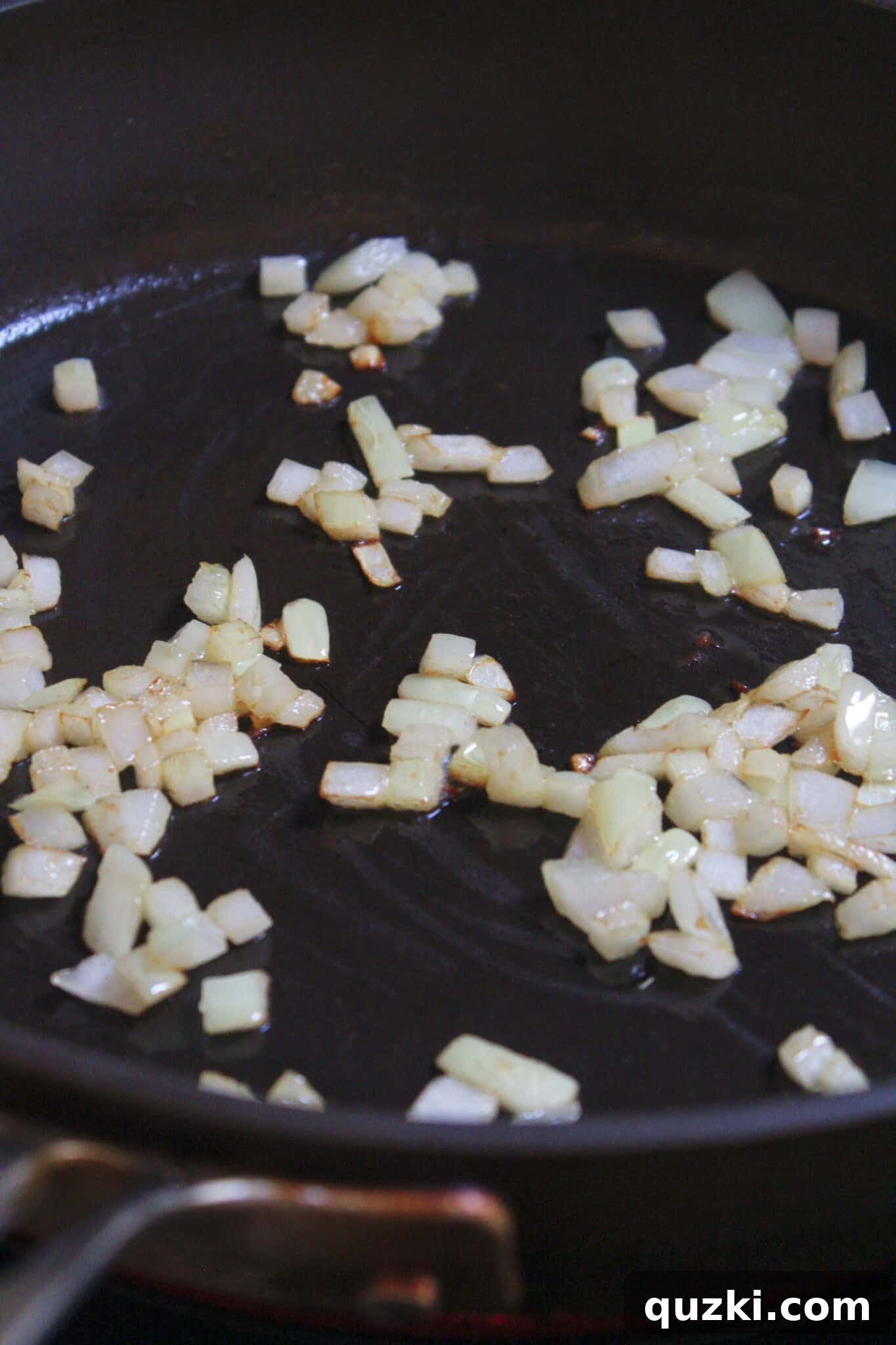 Thanksgiving Leftover Turkey Empanadas: A Delicious Reinvention 6 Chopped onions gently sautéing in a skillet with oil, releasing their sweet aroma as they soften.
