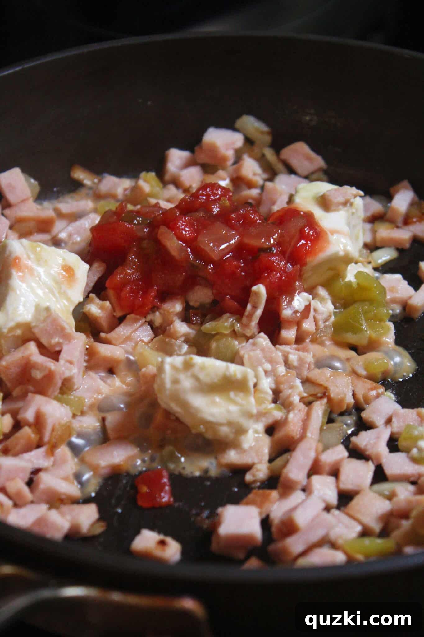 Thanksgiving Leftover Turkey Empanadas: A Delicious Reinvention 8 Salsa being stirred into the creamy turkey, onion, and green chili mixture in the skillet.