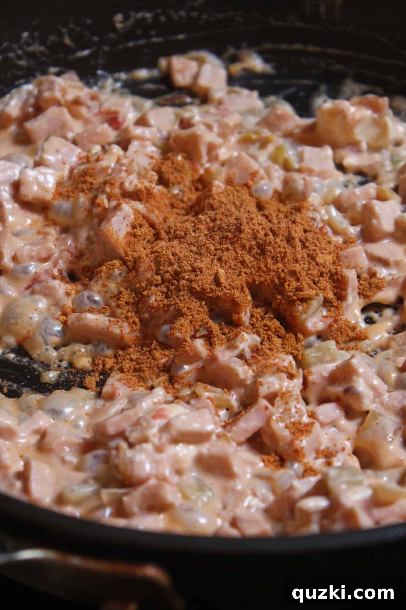 Thanksgiving Leftover Turkey Empanadas: A Delicious Reinvention 9 Taco seasoning sprinkled into the turkey empanada filling, ready to be mixed for a final flavor boost.