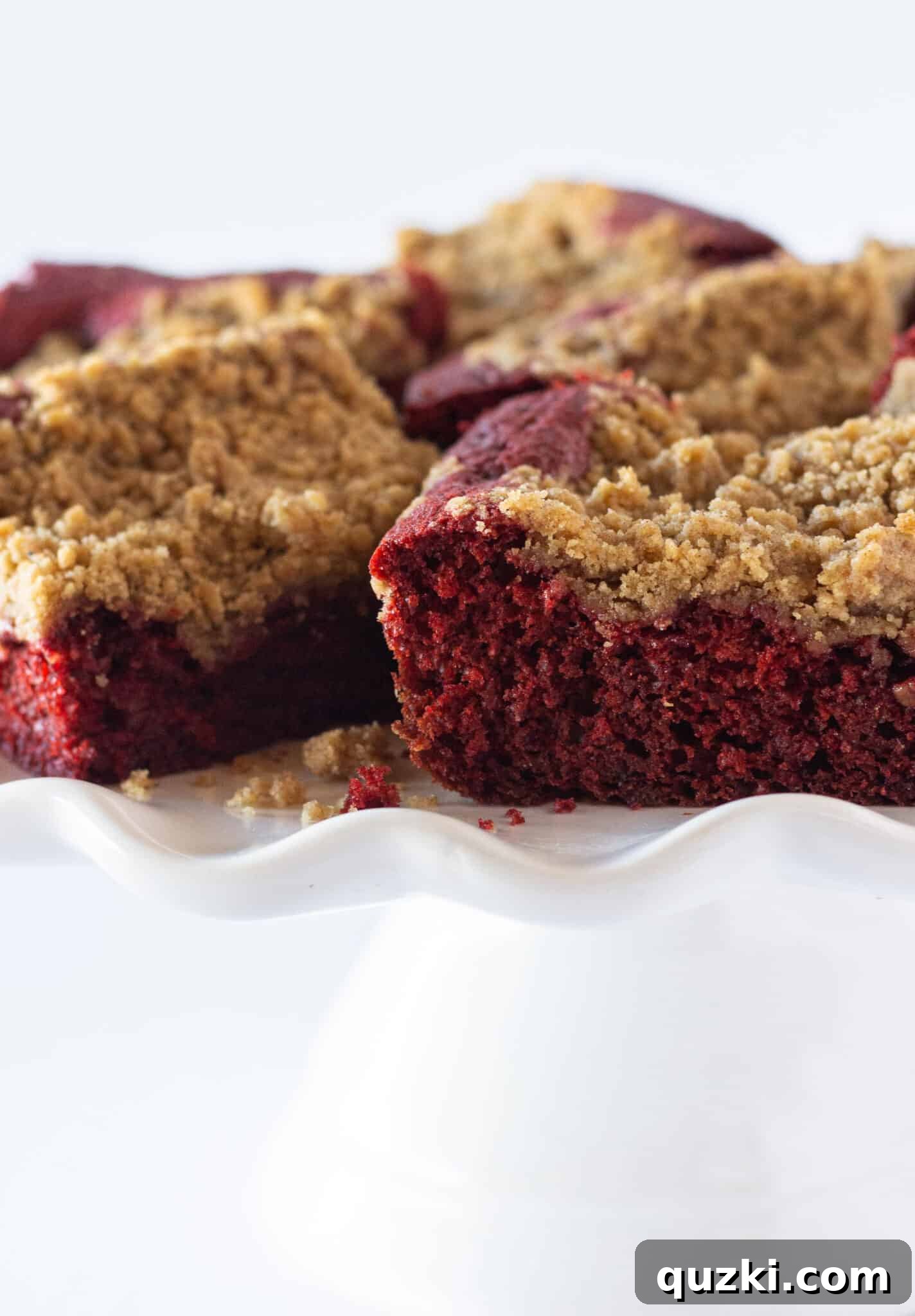 Effortless Red Velvet Crumb Cake From A Box Mix 3 A whole Easy Red Velvet Crumb Cake presented on a decorative cake plate, ready to be served.