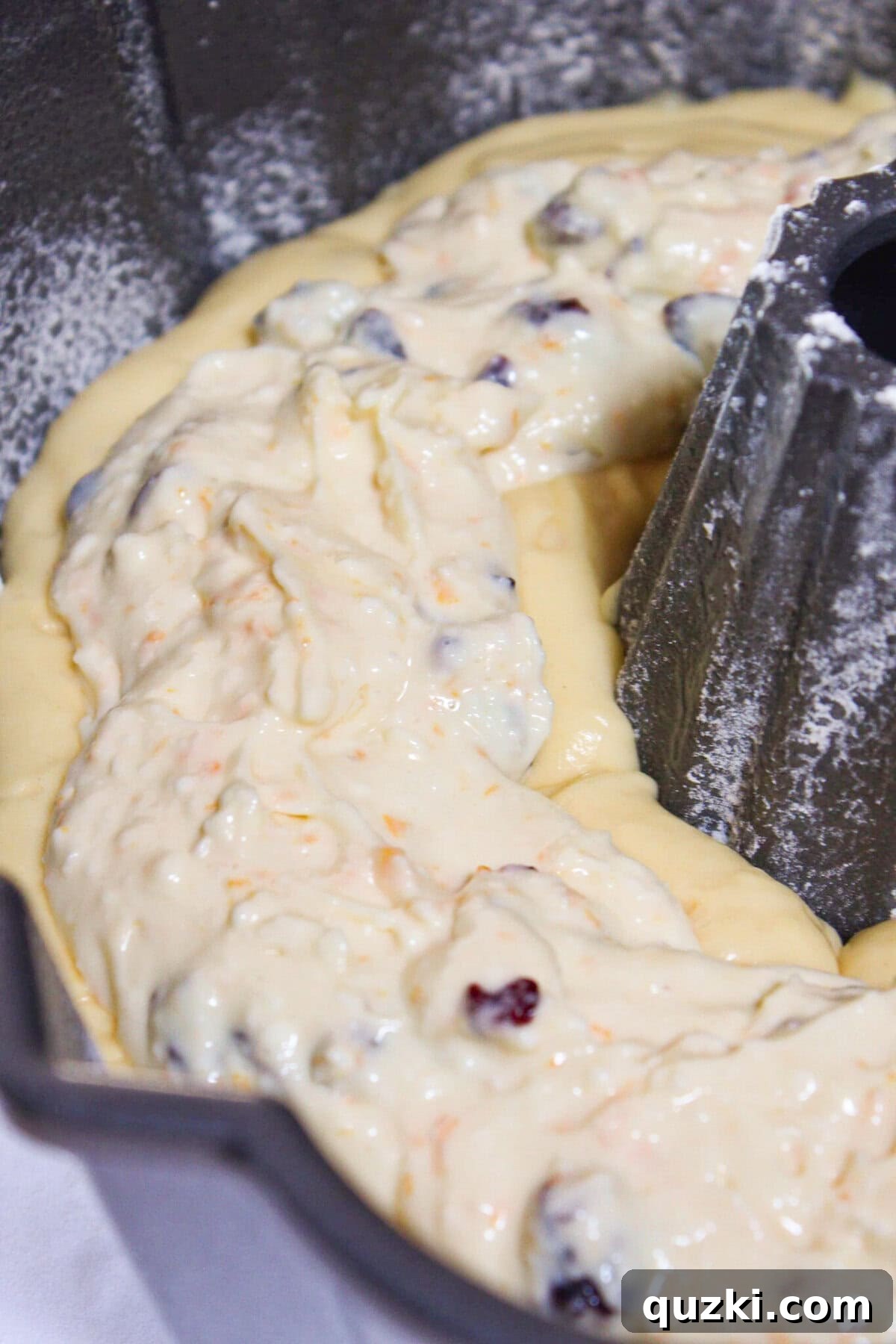 Adding the filling to the bater in the pan and then topping with the rest of the batter.