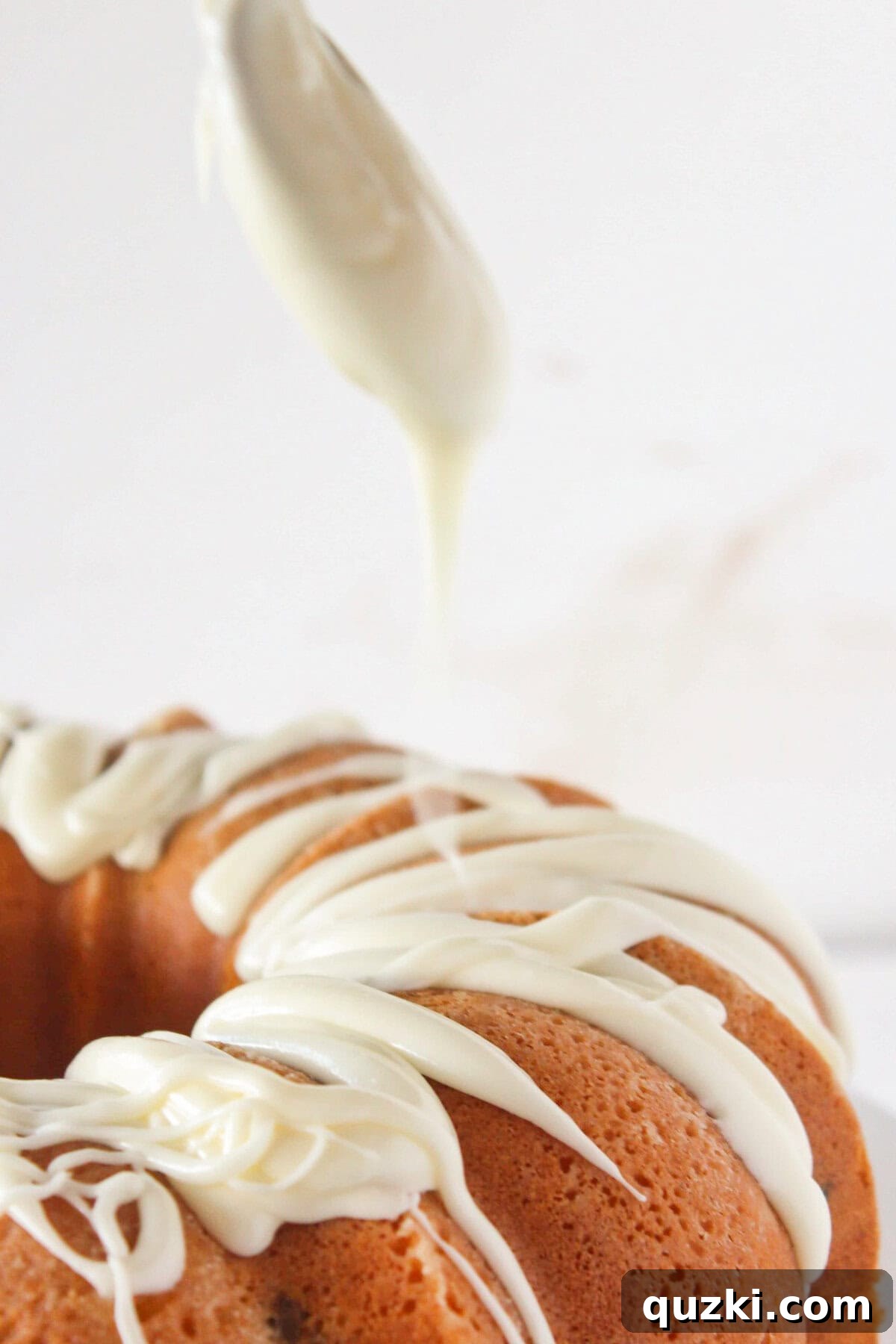Adding the frosting to the top of the cake.