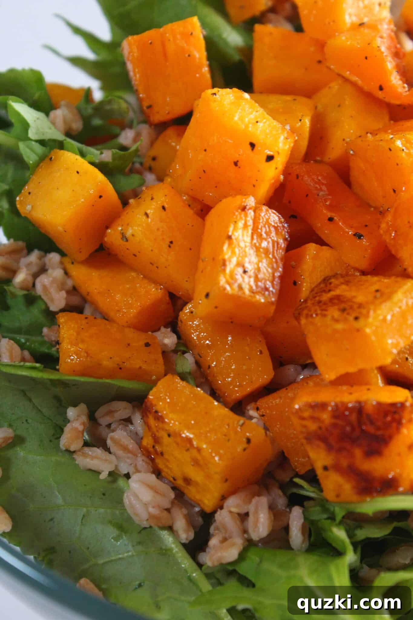 Fireside Winter Salad 6 Farro and squash being gently added to the bowl of fresh greens.