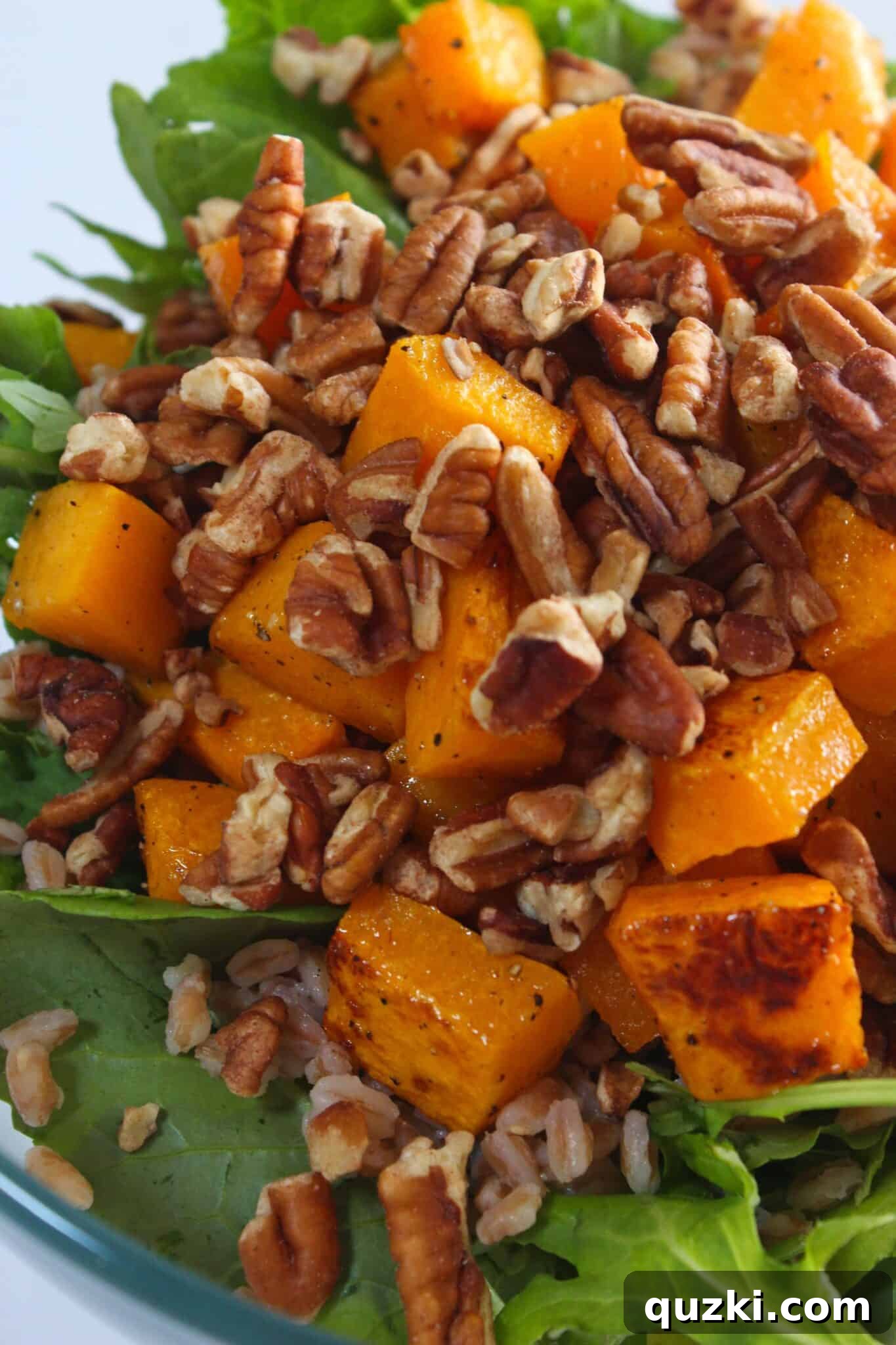 Fireside Winter Salad 7 The salad being tossed with dressing, showing chopped pecans.
