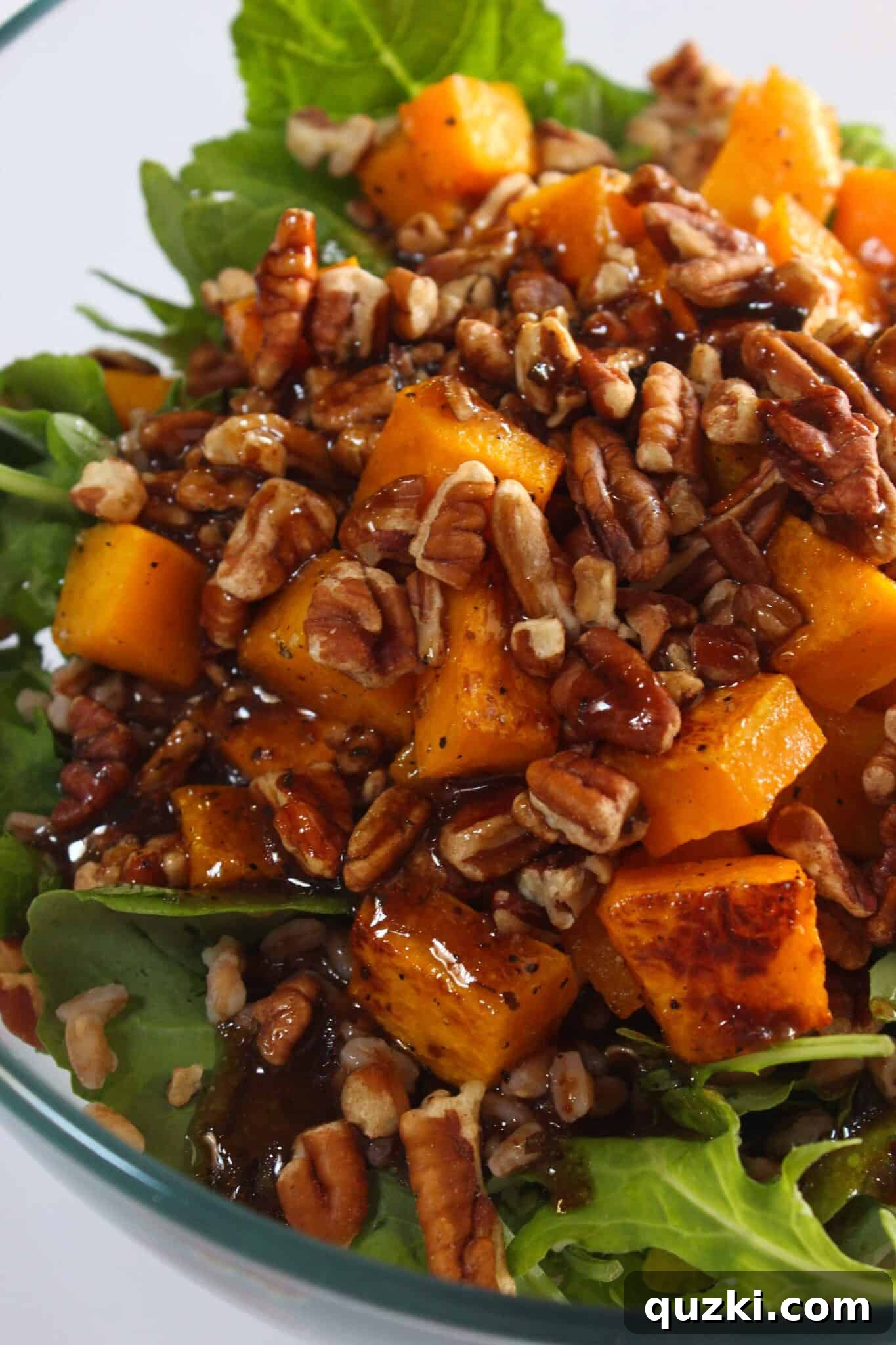 Fireside Winter Salad 8 Finishing the cozy winter salad with a drizzle of dressing and crunchy pecans.