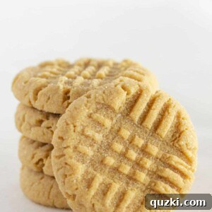 Close-up of a perfectly baked peanut butter cake mix cookie, showing its soft texture and classic criss-cross pattern.