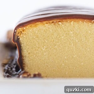 A cross-section of the No-Bake Twix Pound Cake, showing the distinct layers of cake, caramel, and chocolate.