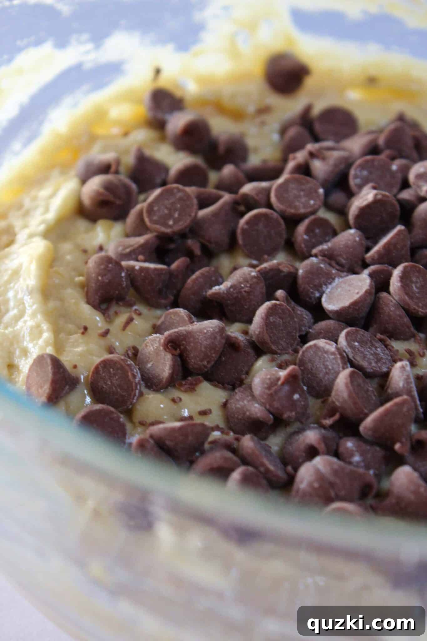 Decadent Banana Chocolate Chip Crumb Cake 7 Folding milk chocolate chips into the Banana Chocolate Chip Crumb Cake batter