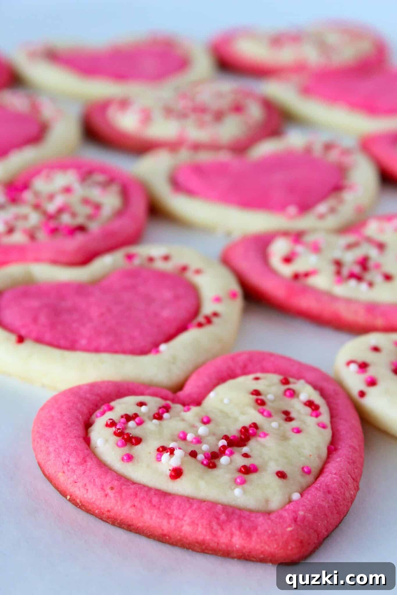 Delicious Easy Valentine's Day Sugar Cookies with pink and white hearts, featured on a top US cookie blog