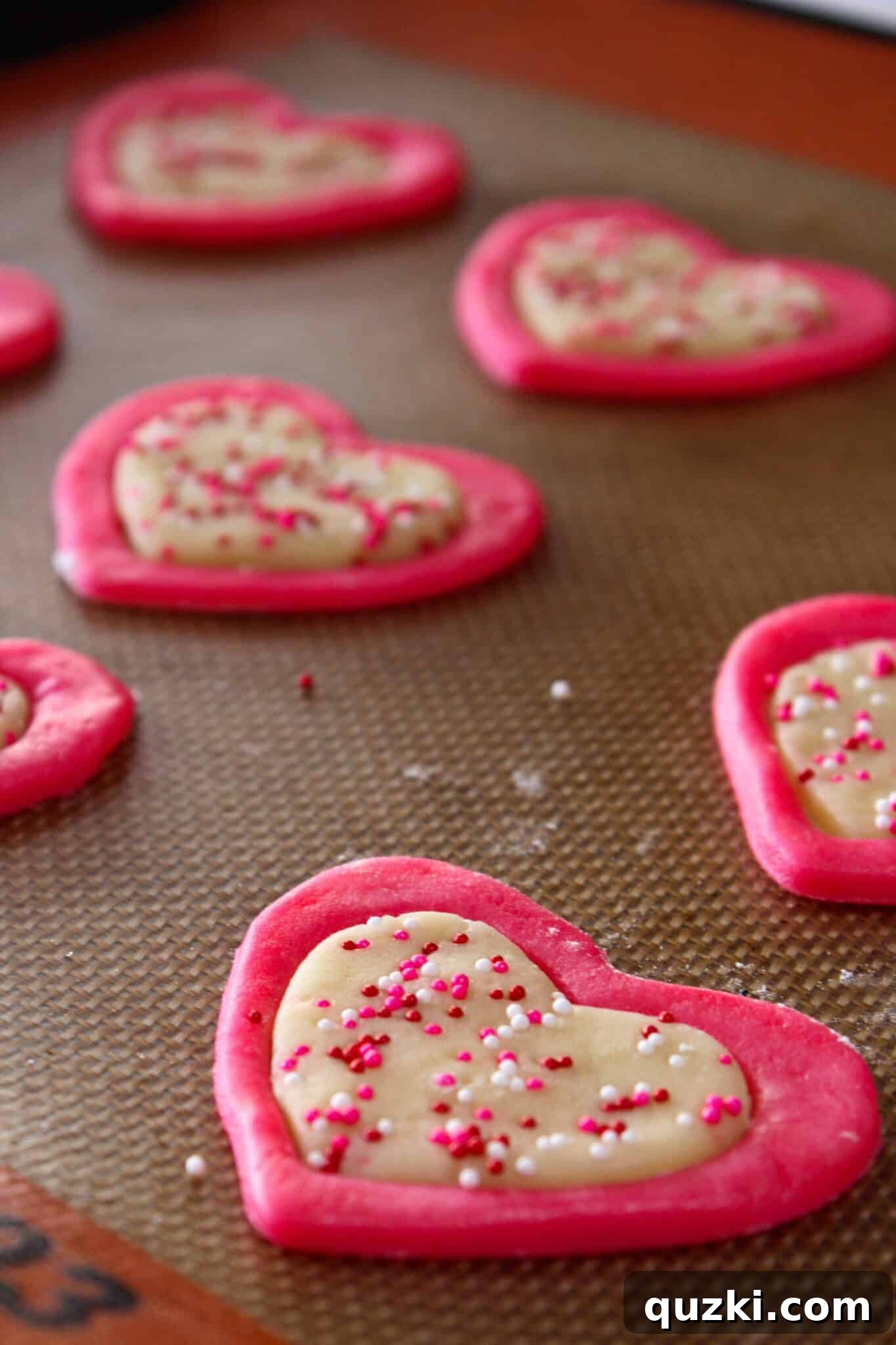 Freshly baked two-tone Valentine's Day sugar cookies cooling on a wire rack