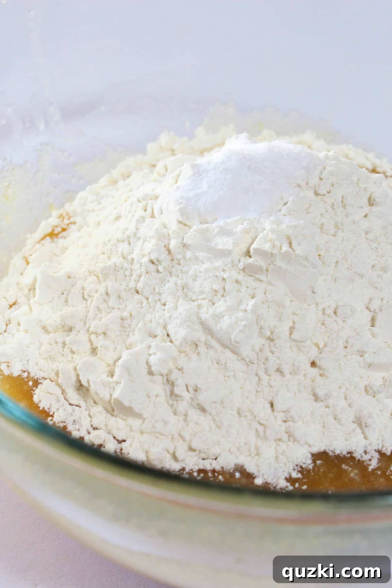 Melt-in-Your-Mouth Soft Chocolate Chip Delights 8 Flour, baking soda, and salt being mixed into the wet cookie dough ingredients.