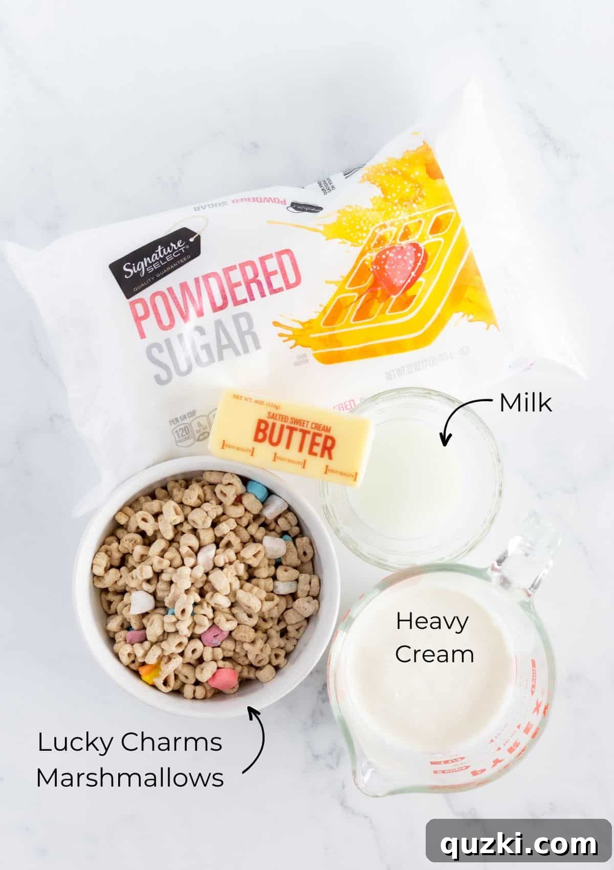 The ingredients required to prepare the unique cereal milk frosting, featuring Lucky Charms cereal, heavy cream, softened butter, and powdered sugar, neatly arranged.