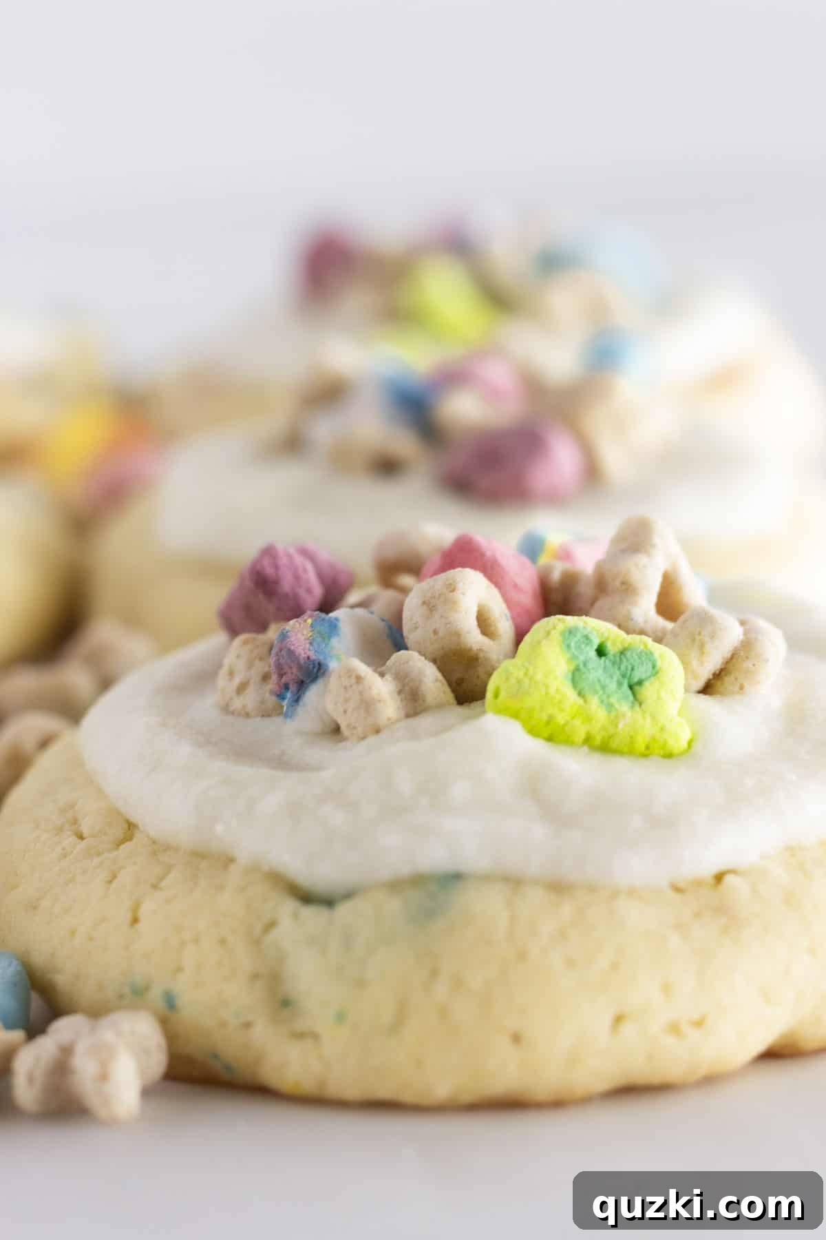 A close-up shot of a single Lucky Charms cookie, showcasing its soft texture, generous frosting, and colorful cereal topping, highlighting its appeal.