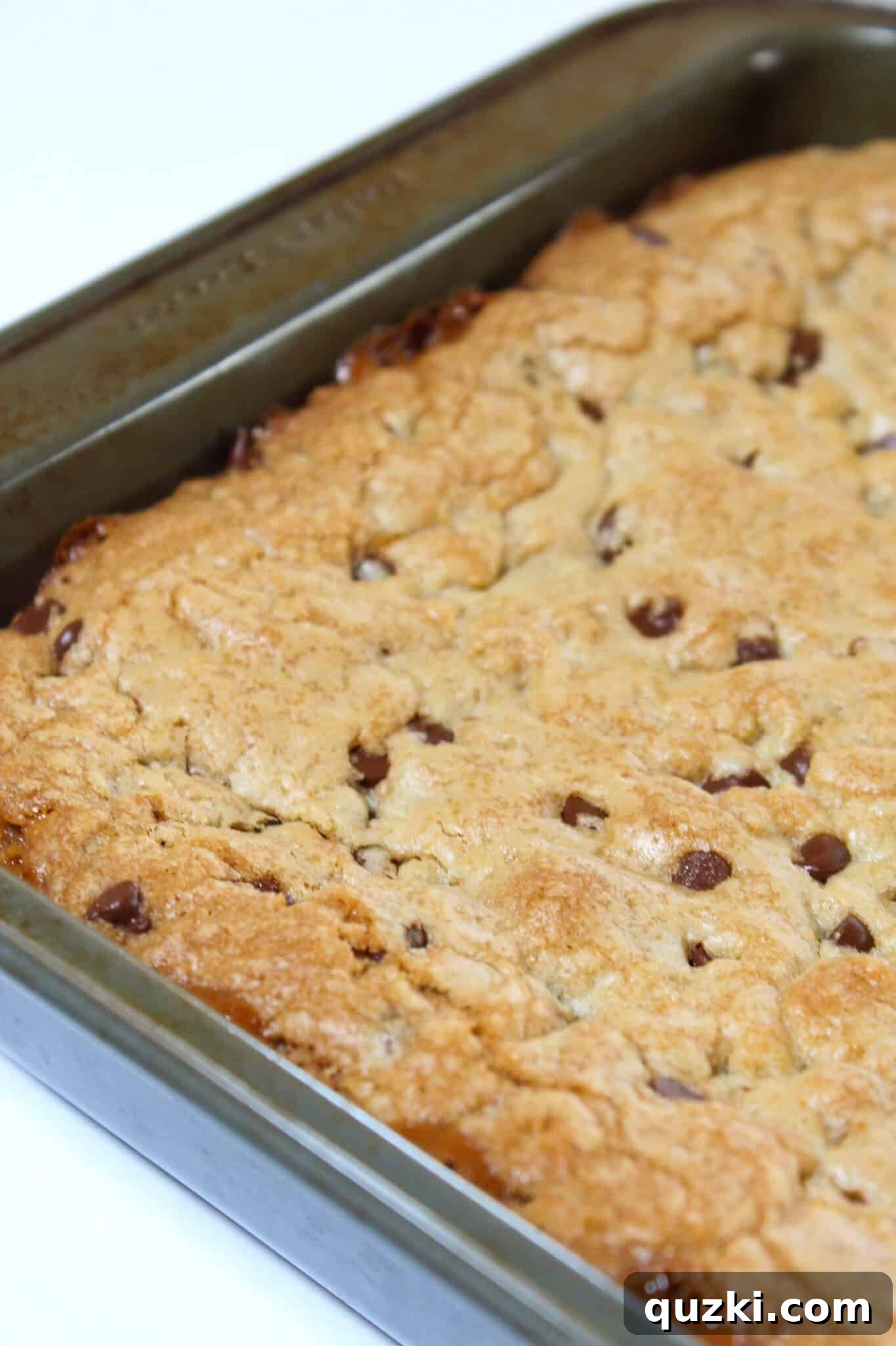 Salted Caramel Chocolate Chip Cookie Bars 12 Baked salted caramel chocolate chip cookie bars cooling in the pan after baking.