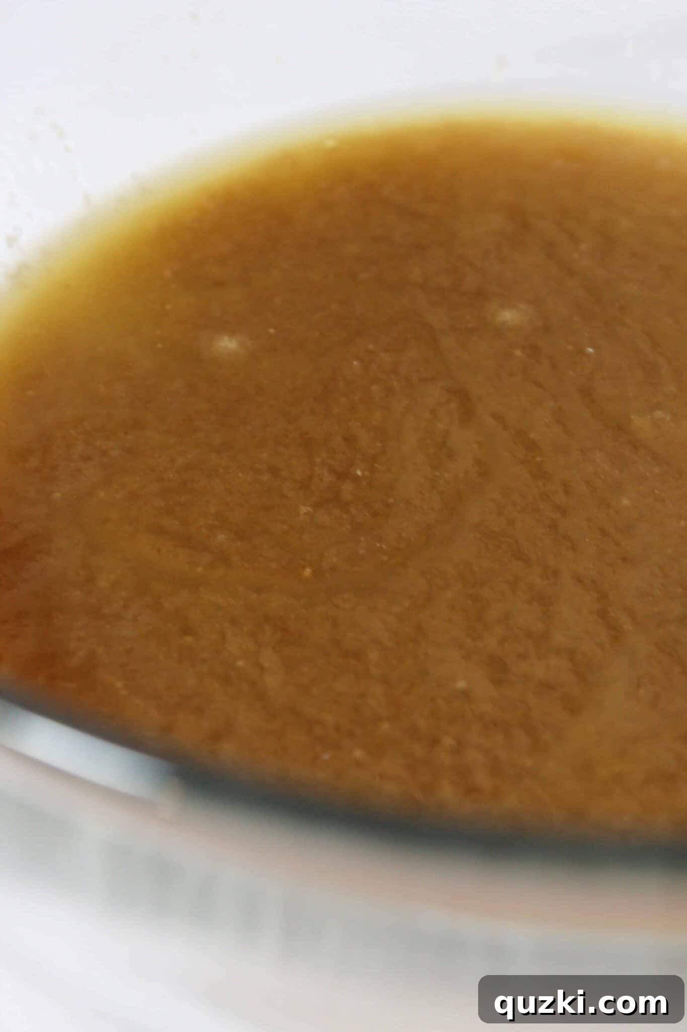 Salted Caramel Chocolate Chip Cookie Bars 4 Close-up of melted butter and sugars being stirred in a bowl to start the cookie bar dough.