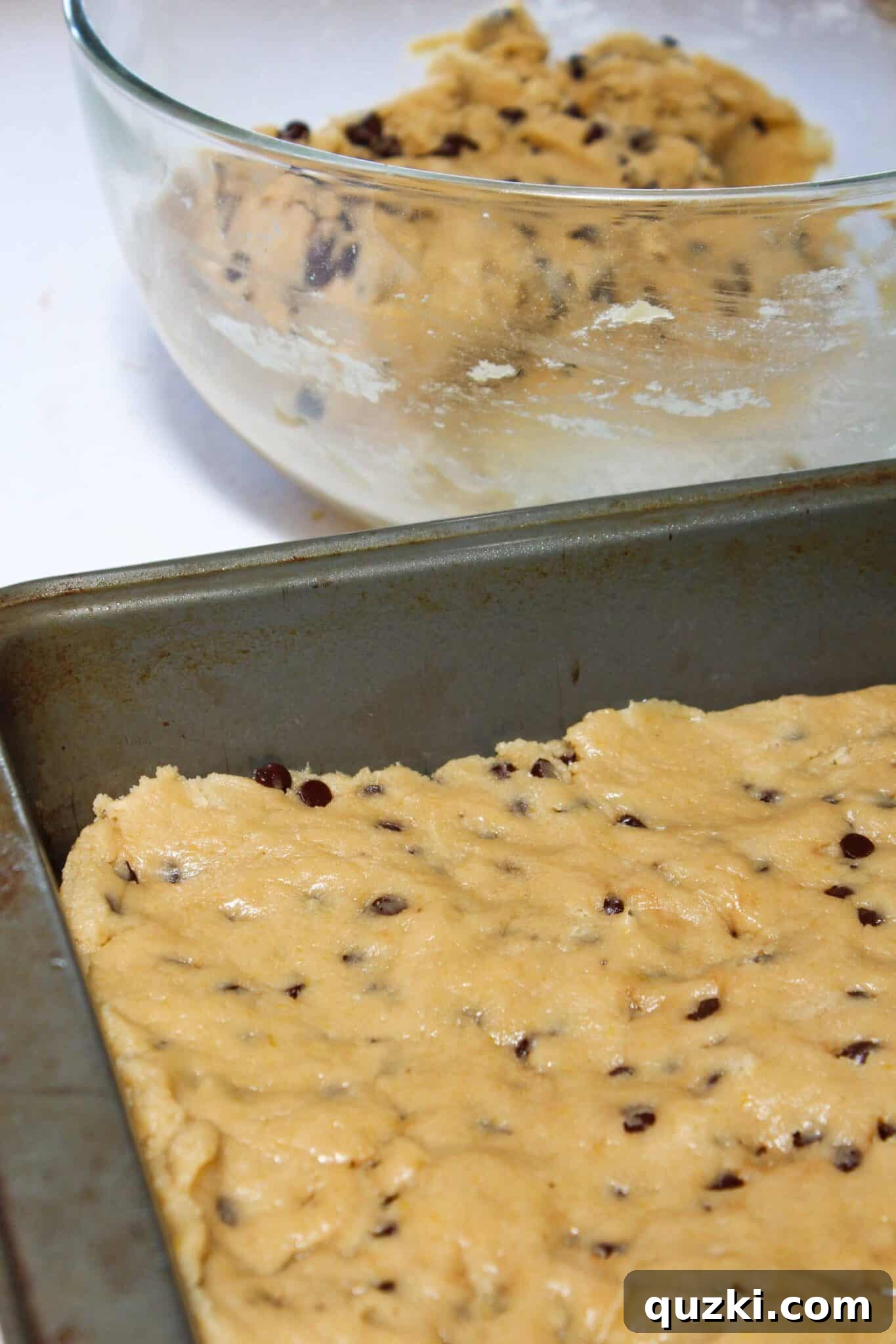 Salted Caramel Chocolate Chip Cookie Bars 8 Pressing the chocolate chip cookie dough evenly into an 8x8 inch baking pan.