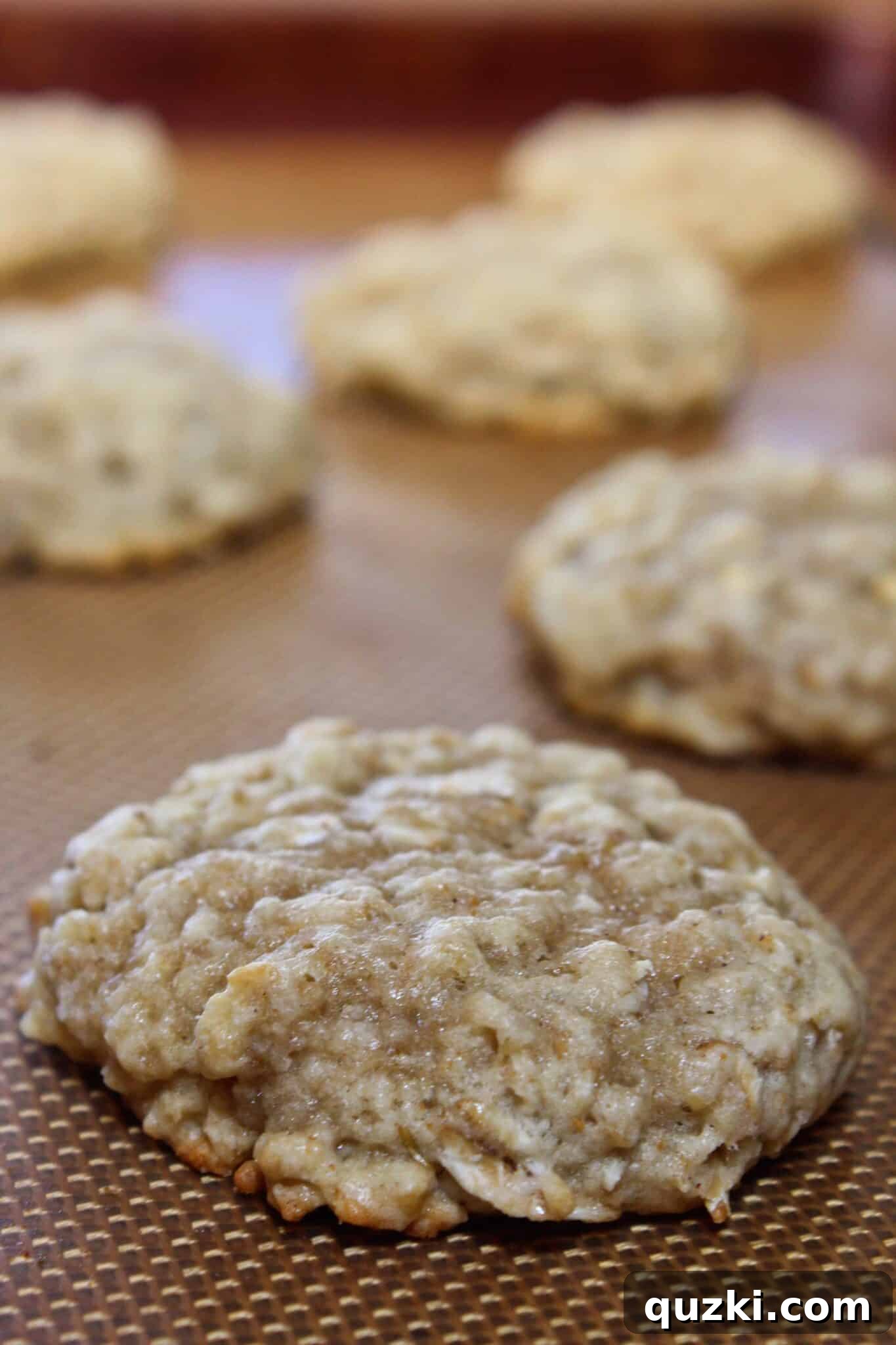 Nutty Brown Butter Banana Oatmeal Cookies 11 Freshly baked Brown Butter Banana Oatmeal Cookies cooling on a baking sheet, showing golden edges and soft centers, ready to be enjoyed.