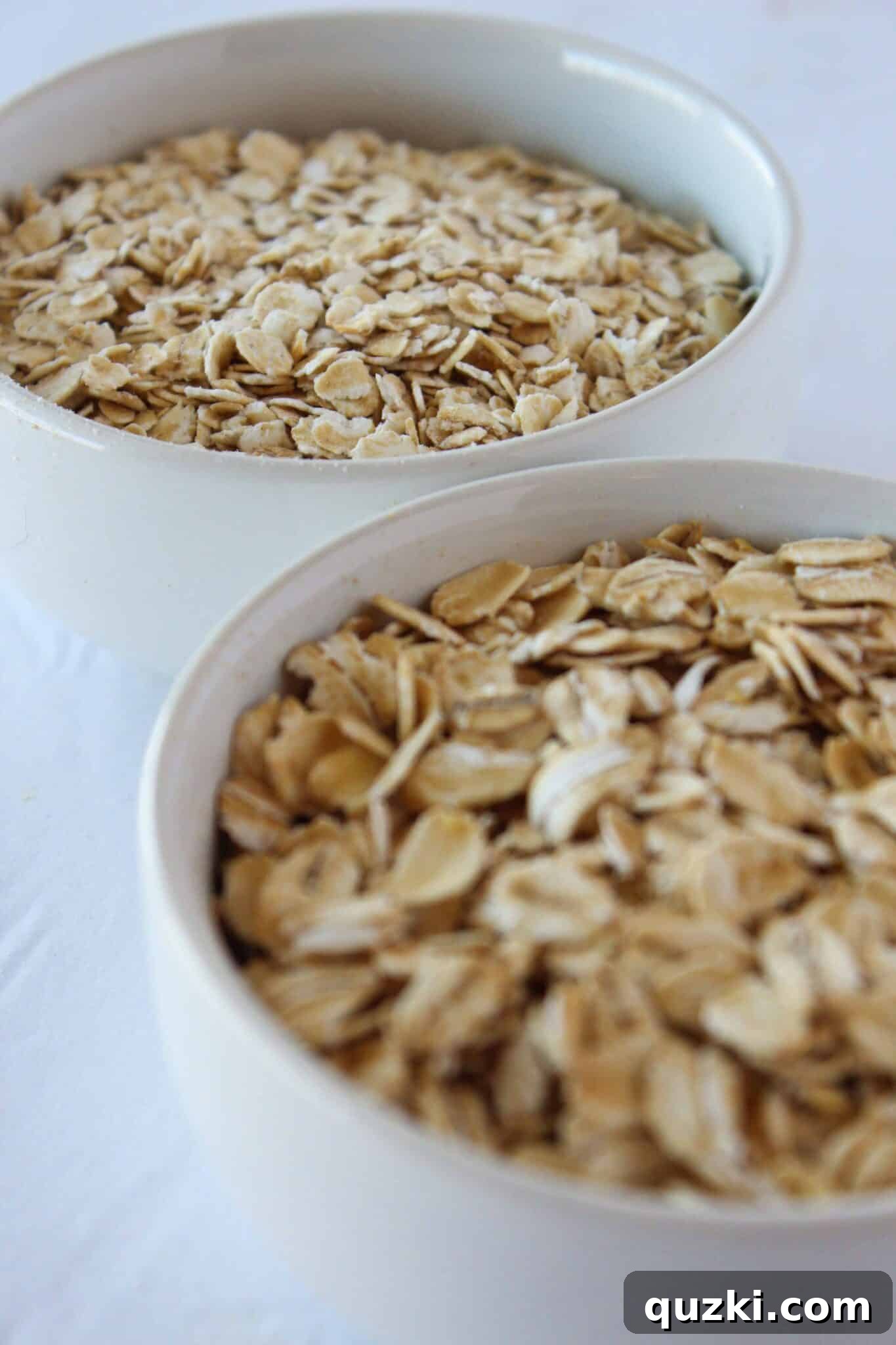 Nutty Brown Butter Banana Oatmeal Cookies 13 Comparison of rolled oats and quick-cook oats side by side, illustrating the size and texture difference crucial for baking brown butter banana oatmeal cookies.