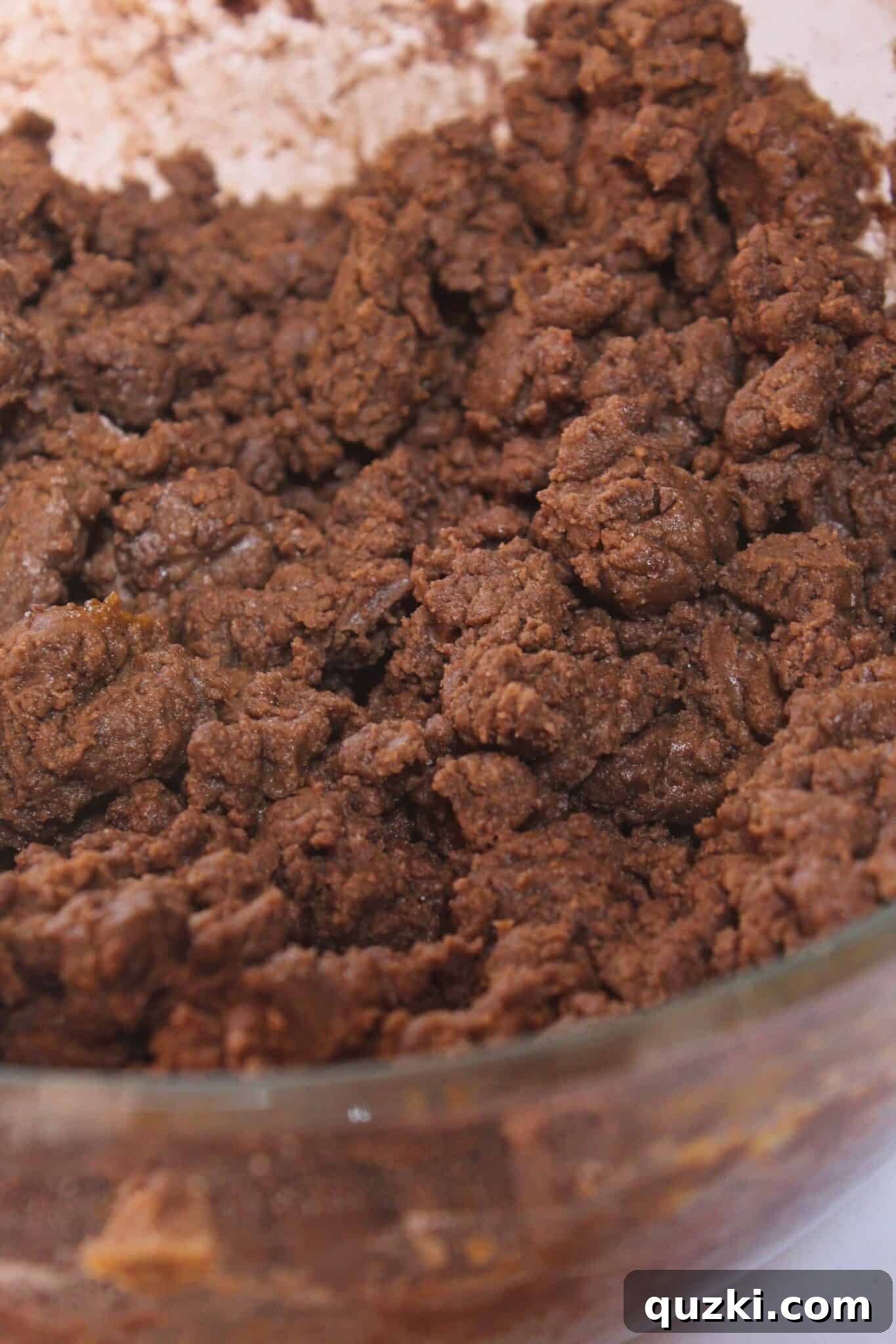 The chocolate peanut butter cookie dough coming together to a thick, consistent texture in the mixing bowl.