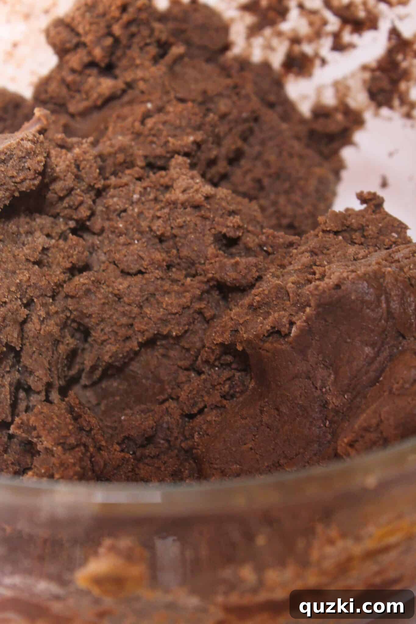 Preparing to roll cookie dough balls in granulated sugar for a sweet, crunchy exterior.