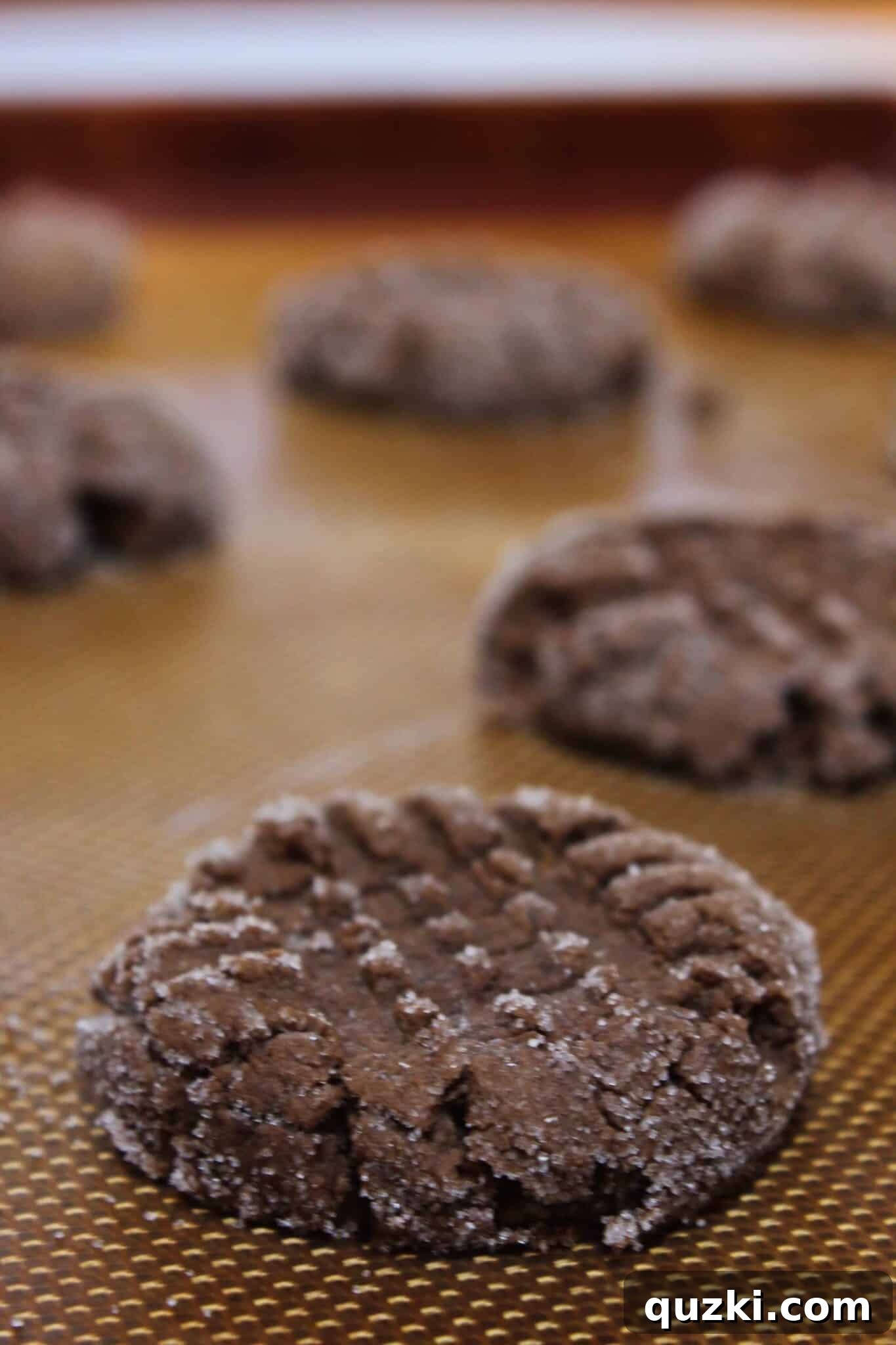 Freshly baked Chocolate Peanut Butter Cake Mix Cookies resting on a baking tray, ready to be cooled and enjoyed.