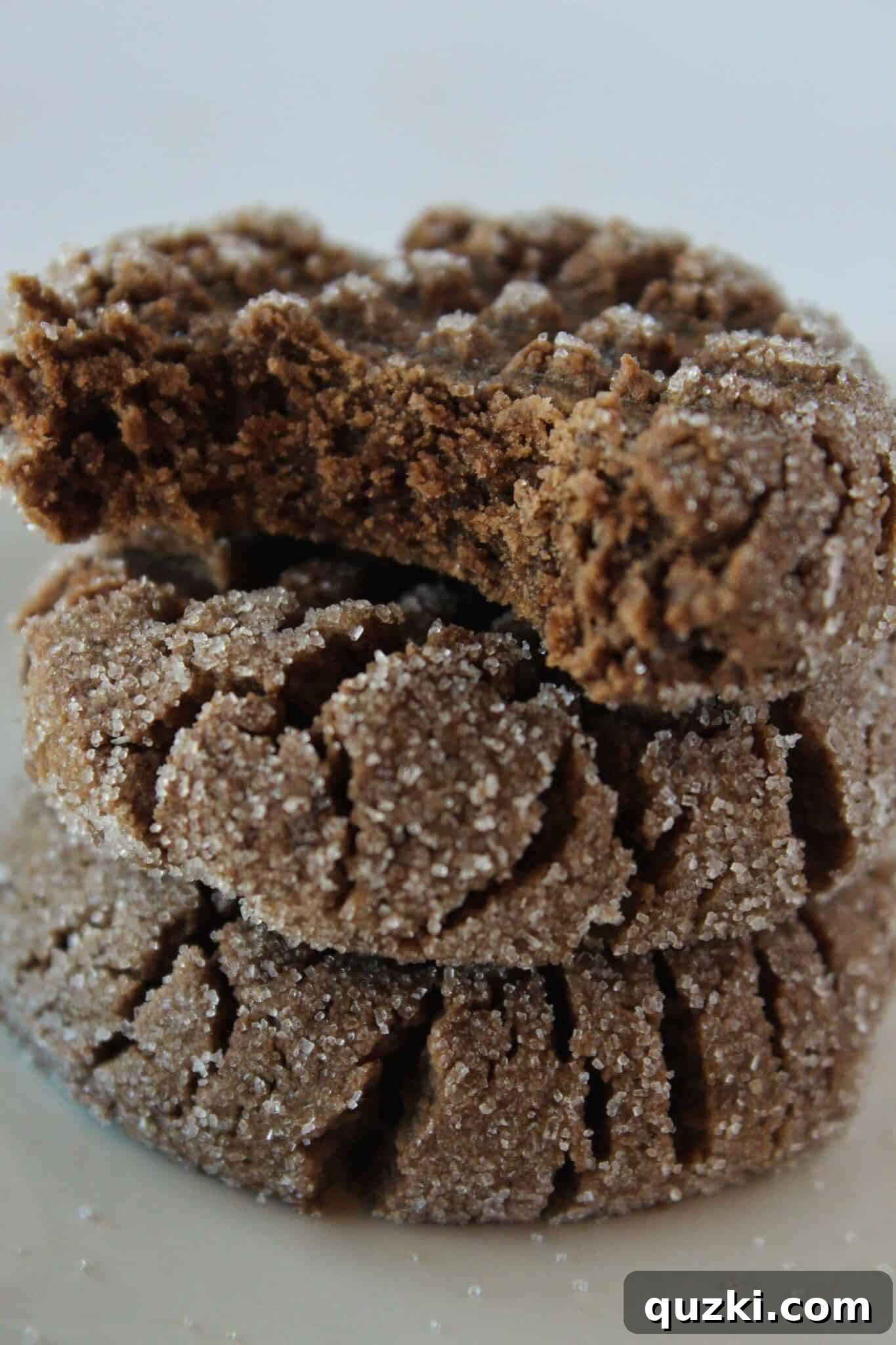 Three perfectly baked Chocolate Cake Mix Cookies with Peanut Butter, stacked invitingly, highlighting their soft centers and rich texture.