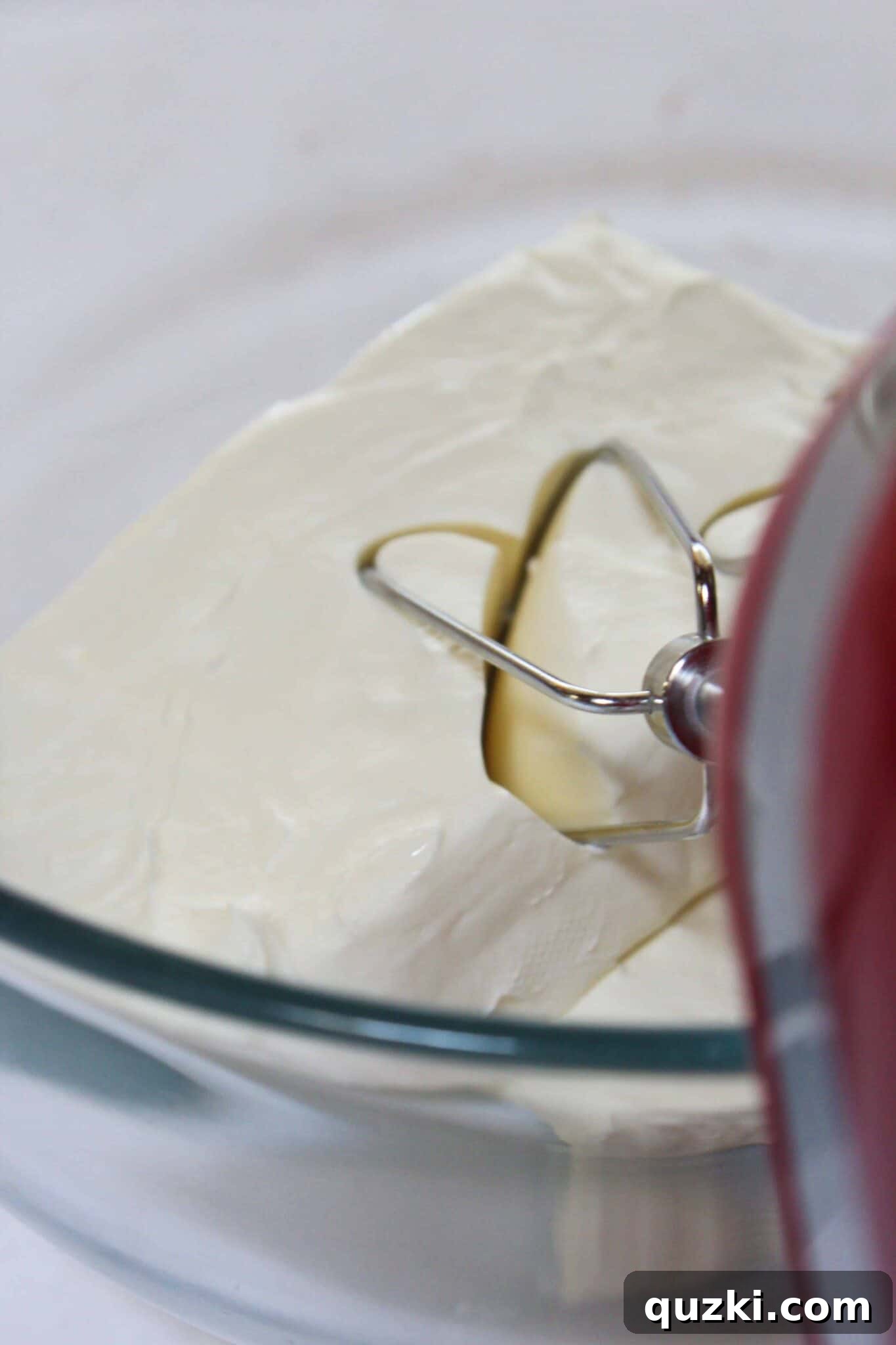 Decadent Mini Raspberry Cheesecake Cups 4 Step-by-step image showing how to combine cream cheese and sweetened condensed milk for the cheesecake filling.